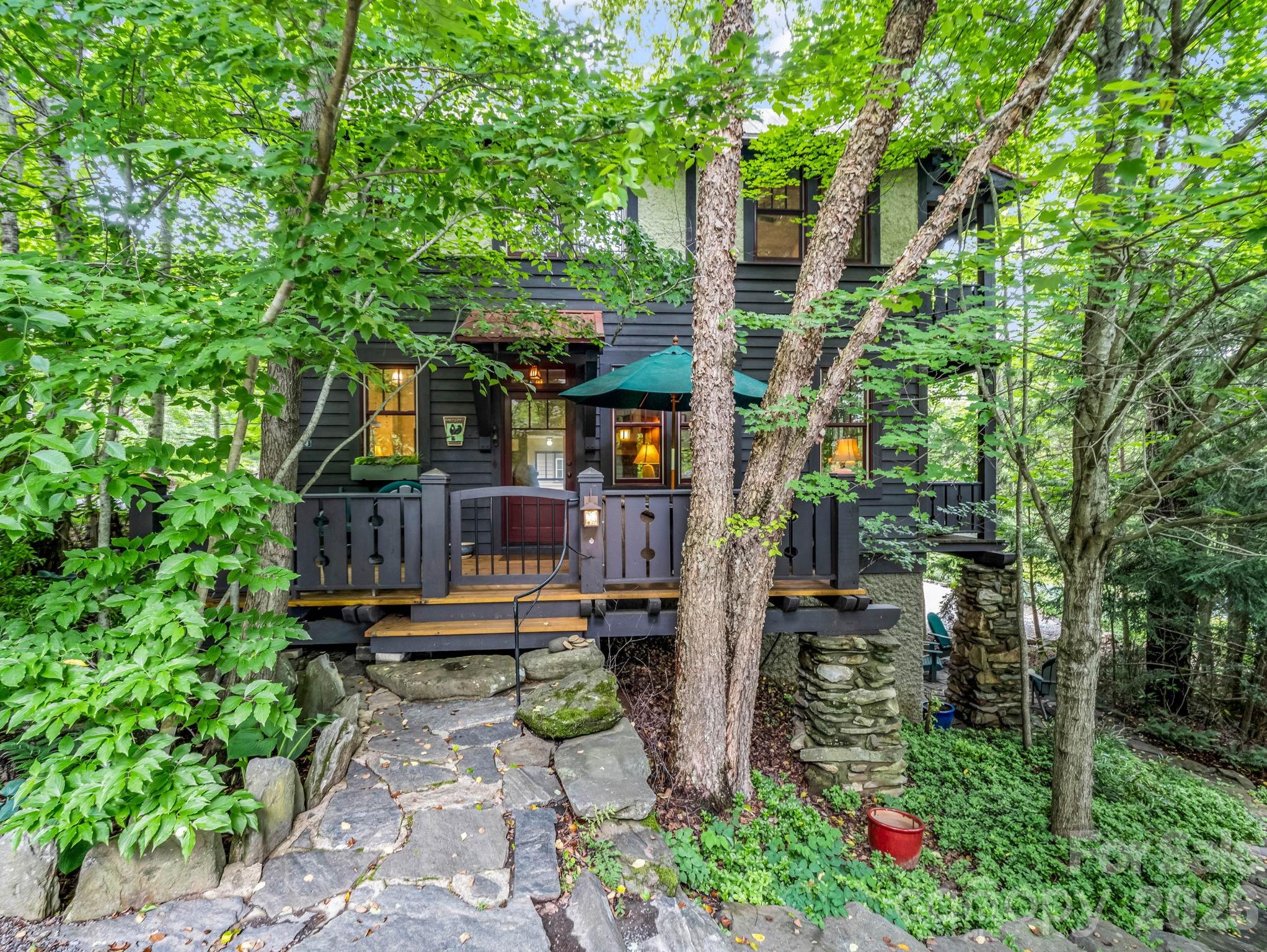 Charming Arts & Crafts home in Cheshire Village with space to build a primary home.  This is a unique property with many architectural details, including beautiful wood floors, extensive wood molding, custom bathrooms, built-in storage, and multiple porches to enjoy this private setting in the trees.  Additional room on the second floor could be used as an office or a small bedroom.  Located in the heart of Cheshire, it offers access to walking trails and beautiful common area, plus a short walk to restaurants, the fitness center and tennis club.  It is minutes from the highway, a grocery store and the center of town.  There is room on the lot to build the primary home of your dreams or use the property as a second home or vacation rental.  Cheshire is one of the best neighborhoods in Black Mountain.
