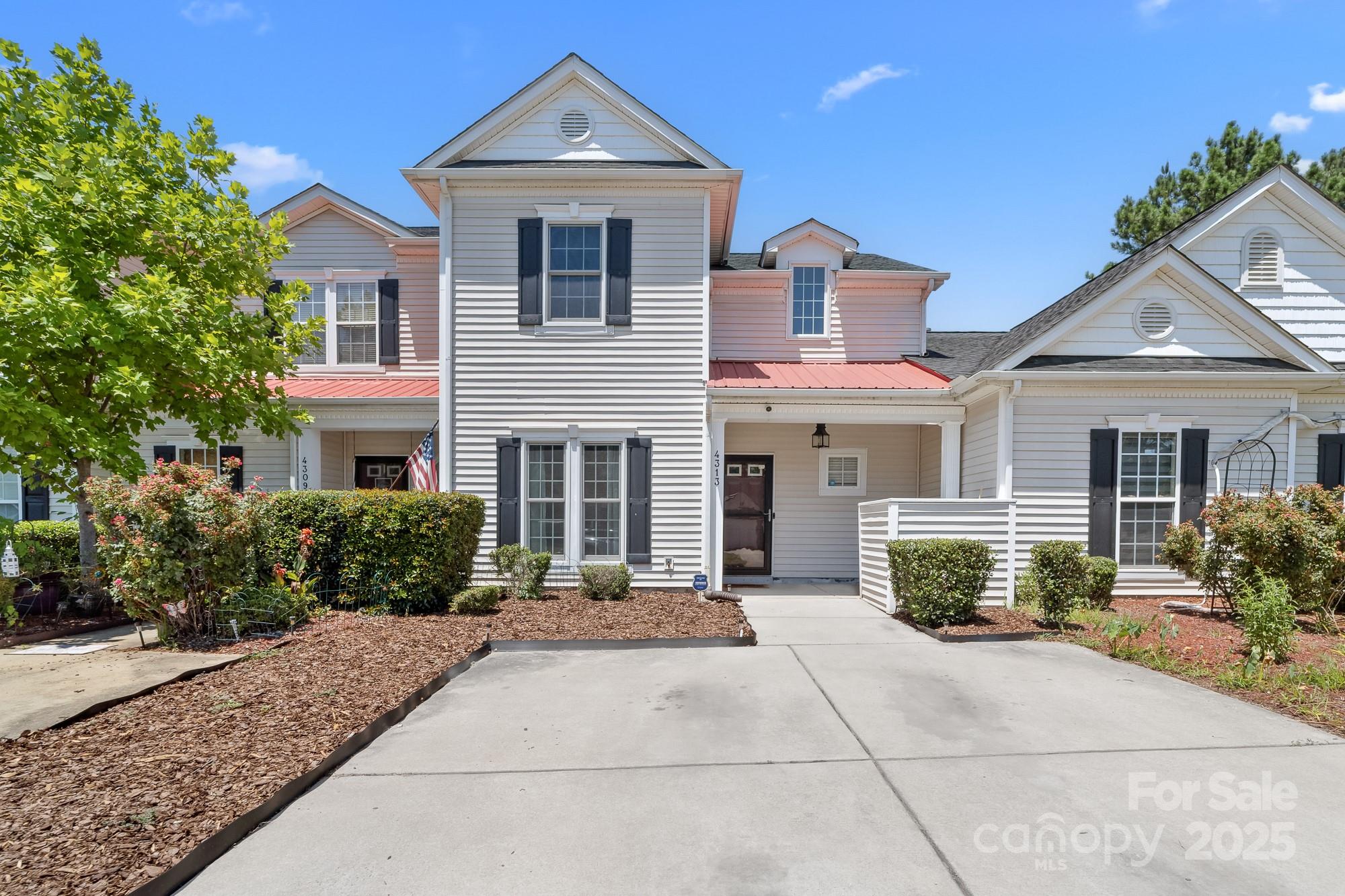 New Paint throughout and new carpet downstairs! Discover comfort and convenience in this beautifully designed, Freshly Painted, 3-bedroom, 2-bathroom townhome located just 5 miles from Uptown Charlotte. Featuring a sought-after primary suite on the main floor with brand new carpet, this home offers the perfect blend of functionality and style. Step inside to an open floor plan filled with natural light, highlighted by rich hardwood flooring and a dramatic two-story great room that overlooks a private, fenced in backyard. Ideal for entertaining or quiet relaxation. Upstairs, an open loft provides a versatile space for a home office, playroom, or reading nook, all while offering a stunning view of the living area below. Enjoy community amenities including a sparkling pool and green space, all within a well-maintained neighborhood close to all the Plaza Midwood and NoDa have to offer!