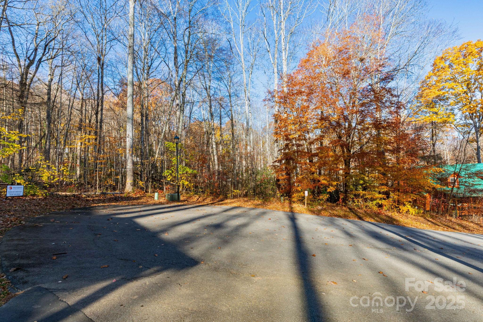 READY TO BUILD! A wonderful opportunity in Maggie Valley to get a level lot with easy, paved access, & city water & sewer! This property checks the boxes. The year-round access is easy with gently, wide paved roads. There is electricity to the lot along with wired cable and internet. A beautiful mountain stream on the backside of the property would be the perfect spot to have your deck overlook and have a cup of coffee in the morning or even have a hot tub and unwind taking in the crisp mountain air. Located in the Twin Brooks Resort Community lot owners will have access to the amenities that include the indoor pool, clubhouse, playground, and common area. HOA dues are $1200 per year which covers the road maintenance, pool, amenities, and exterior grounds maintenance. This is the largest lot in the community. Dont wait, call and make your appointment today!