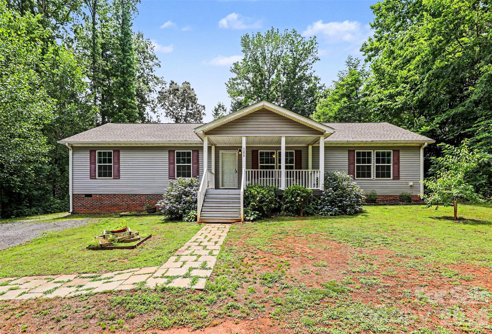 Welcome to 11913 Platon Avenue in Huntersville, NC 28078 -one-level home with 3 bedrooms, 2 full baths, approximately 1,724 sq ft, a split-bedroom floor plan, and no HOA. Located on a 0.34-acre lot with a private backyard and wooded treeline, this Huntersville home offers open living space, outdoor living, and convenient access to I-77, Birkdale Village, shopping, dining, and Lake Norman-area amenities.

Inside, the living room, dining area, and kitchen connect in an open-concept layout designed for everyday living and gathering. The kitchen features a center island and opens to the dining area with sliding glass doors leading directly to the rear deck. A separate laundry room adds convenience and provides additional access to the deck.

The large primary bedroom is privately positioned on one side of the home and features a spacious walk-in closet and private bathroom. Two additional bedrooms and a full hall bath are located on the opposite side of the home, creating a desirable split-bedroom layout. A flexible den offers additional space for a home office, hobby room, exercise area, playroom, or guest space.

Outdoor features include a large rear deck with retractable awning, ground-level patio, covered front porch, gravel driveway with ample parking, detached storage sheds, and a flat backyard with wooded privacy. Recent updates include a 2026 roof and leaf gutter guards. HVAC was installed in 2018. The home currently operates on well and septic.  Zoned for Barnette Elementary, Francis Bradley Middle, and Hopewell High School.

Above-ground pool may remain or seller will remove prior to closing, based on buyer preference.