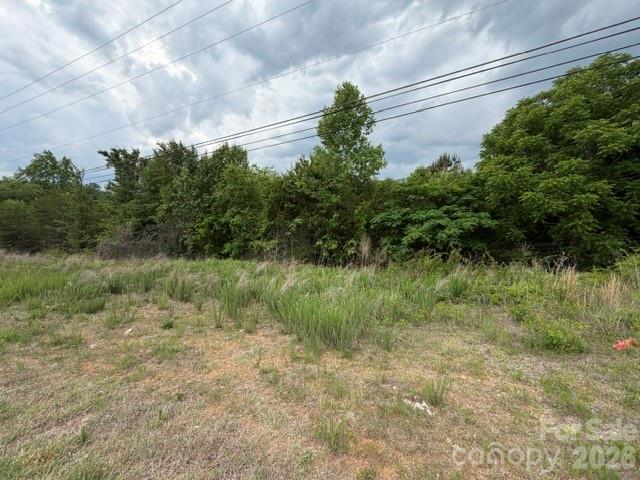 Approximately 17 acres ideally located just minutes from I-40 and Hwy 321 with access from both Old Shelby Road and Oglesby Lane. This versatile property consists of 3 tracts and offers a mix of wooded areas and cleared land, providing endless possibilities for residential development, recreation or investment. A creek runs through the property adding to its natural beauty and privacy. Conveniently located near Henry River Park. Water and sewer are available through Long View (tap fees required). A large power line easement crosses a portion of the property. Great opportunity for acreage close to major highways, shopping, dining and more.
