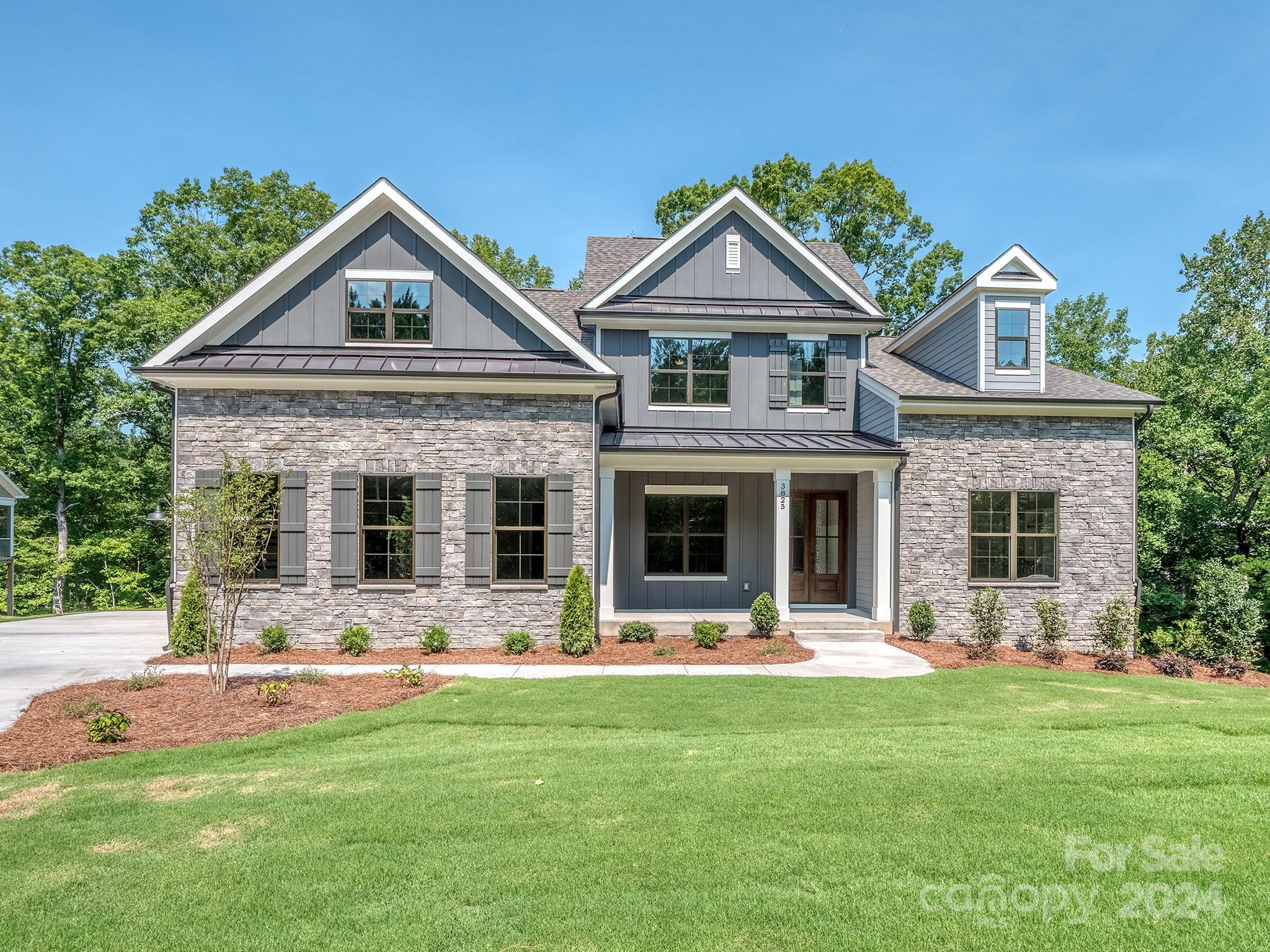 Beautiful new construction in the lake front community, Handsmill on Lake Wylie. This 5 bedroom, 4.2 bath home features .75ac overlooking beautiful hardwoods and a Lake Wylie creek. 1st Fl has a spectacular open kitchen, great room with fireplace, mud room with drop zone leading to laundry rm and 3-car garage, great covered deck with fireplace, office/flex space and a primary bedroom with large bath and custom closet. 2nd Fl features 3 bedrooms 2 baths and a large bonus room with plenty of storage.  Basement is perfect for multi-generational living with full kitchen, dining, media/workout rm, great room, and a second primary bedroom with large closet and bath.  Home also includes full irrigation and structured wiring for networking, speakers and security.  Handsmill is one of Lake Wylie's premier custom communities, featuring a quiet atmosphere, a community pool with clubhouse, walking trails and just minutes from top rated Clover schools, restaurants, and shopping. Ready Now!!