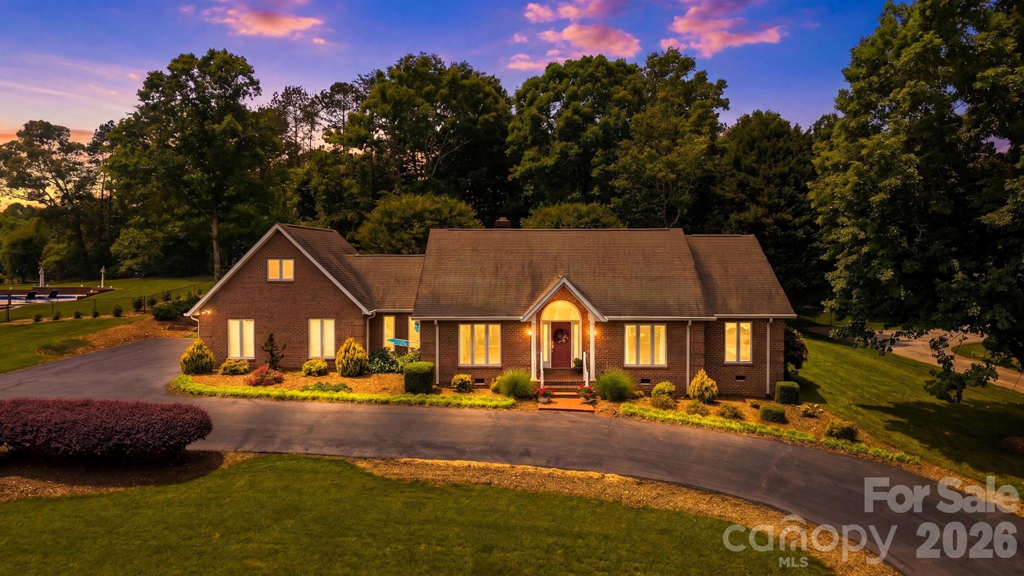 1.42 Acres in Catawba Springs! Being sold by original owners!

Located in the desirable Catawba Springs subdivision, this beautifully maintained all-
brick home offers spacious living, thoughtful updates and a peaceful N.E. Hickory setting with exceptional indoor and outdoor features. Situated on approximately 1.42 acres. Conveniently located near shopping, dining and everyday amenities, this property combines comfort, functionality and flexibility in one impressive package.

The home sits on 0.62 acres and includes the adjacent .80-acre lot. This combination
of size, acreage and location rarely becomes available!

A covered front porch welcomes you into the impressive entry foyer featuring a vaulted
ceiling and warm hardwood flooring that continues throughout much of the main living
areas. The spacious living room features hardwood floors, a stunning stacked-stone
fireplace and direct access to both the covered patio and additional uncovered paver
patio, creating seamless indoor and outdoor living spaces ideal for entertaining or relaxing.

The kitchen offers hardwood flooring, abundant cabinetry, a center island with
breakfast-bar seating, walk-in pantry and appliances including, dishwasher, range,
refrigerator and microwave.

The adjoining breakfast nook features hardwood flooring and opens directly to the
patio area overlooking the beautifully landscaped backyard. Just outside, enjoy a
peaceful atmosphere created by the goldfish pond and waterfall feature.

The formal dining room adds additional entertaining space with hardwood floors,
crown molding and chair rail molding.

The primary suite serves as a relaxing retreat with newly installed carpet flooring,
ceiling fan, private patio access, walk-in closet and a beautifully appointed ensuite
bathroom complete with heated tile floors, double vanity, walk-in tile shower and
separate tub.

Two additional bedrooms each feature carpet, ceiling fans and significant storage
space. The secondary full bathroom includes LVP flooring, a tile backsplash, large
granite vanity and an attached laundry room. A half-bath with hardwood flooring is also
located on the main level.

The fourth bedroom is located upstairs and includes carpet flooring and a mini-split system for additional comfort. This room also provides flexibility for a home office, media room, or hobby space.

Additional features include a two-car garage, wide doorways for wheelchair accessibility, commercial-grade dehumidifier and new gutters. The sellers have maintained a regular Orkin service schedule with quarterly visits.

With approximately 2,816 square feet, 4 bedrooms, 2.5 bathrooms, all-brick
construction, flexible living spaces, stunning outdoor features and a sought-after N.E.
Hickory location, this well-cared-for Catawba Springs property offers the perfect blend
of comfort, convenience and long-term value.