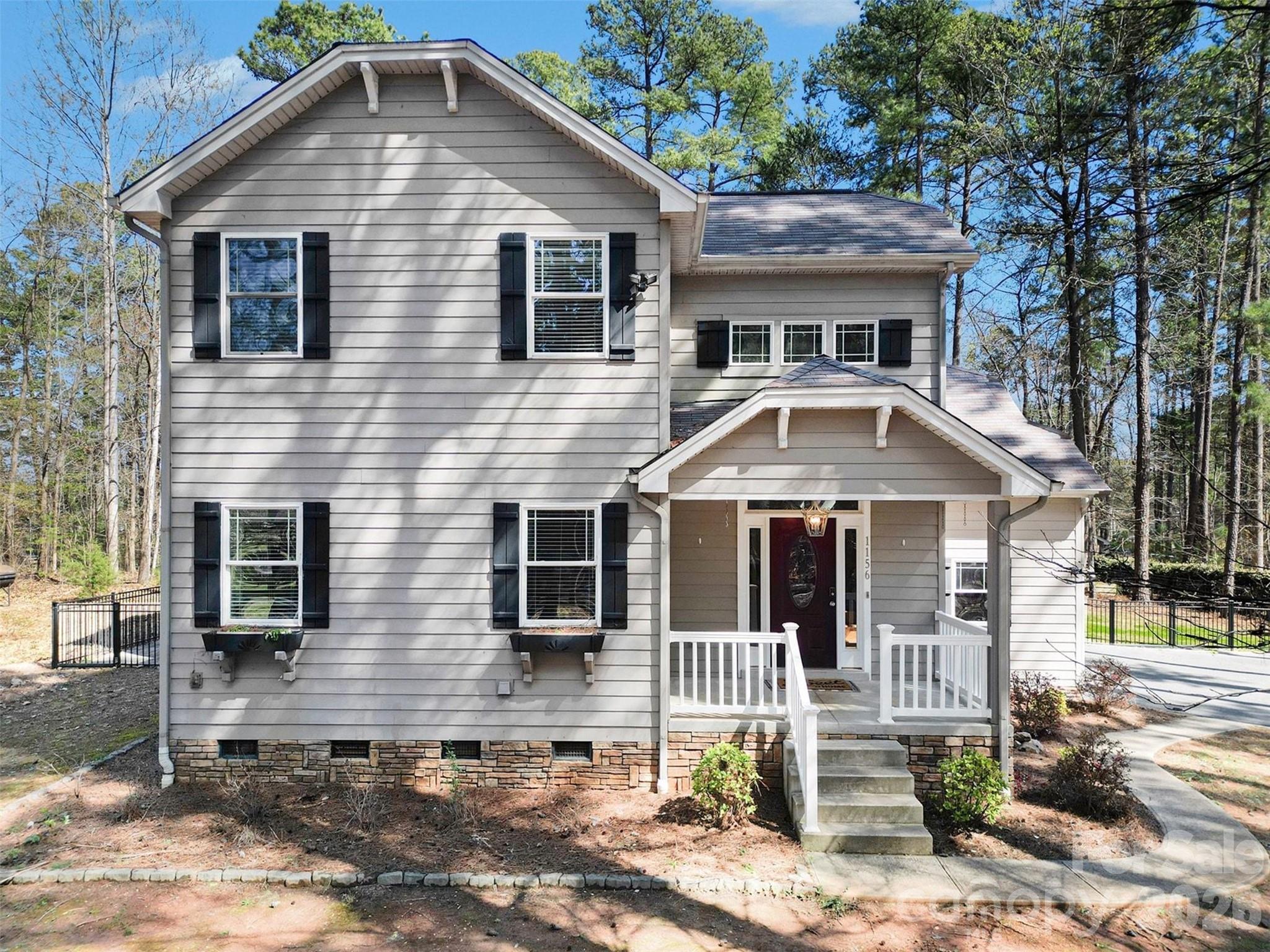 Set on a large, private lot in Denver, this beautifully maintained home offers a peaceful setting surrounded by mature trees and natural landscape, creating a true sense of privacy while still being conveniently located near Lake Norman amenities . Situated on approximately 0.70 acres, the property provides plenty of space to enjoy both indoor and outdoor living.

Inside, the home features a bright and inviting layout with well-defined yet connected living spaces. The main level offers a welcoming flow between the living room, dining area, and kitchen, creating a comfortable environment for both everyday living and entertaining. Large windows throughout bring in natural light and offer views of the surrounding property.

Upstairs, the bedrooms provide comfortable retreats, including a spacious primary suite that serves as a true private escape. The primary bedroom features its own sitting room, creating a versatile space perfect for a reading nook, home office, or quiet lounge area. This added space enhances the suite’s sense of comfort and separation, making it an ideal place to unwind at the end of the day. Additional bedrooms offer flexibility for guests, hobbies, or everyday living needs.

The outdoor spaces are a standout feature of this home. A spacious screened-in porch provides the perfect place to relax year-round while enjoying the peaceful backyard setting. Just beyond, a beautifully designed wooden pergola creates an additional outdoor living area, ideal for gathering with friends, dining, or unwinding in the shade. The expansive yard offers plenty of room for recreation, gardening, or simply enjoying the quiet surroundings.

Located in the Denver area near Lake Norman, the property offers easy access to boating, parks, shopping, and dining while maintaining a private, tucked-away feel. This home combines space, outdoor living, and a serene setting to create a truly inviting place to call home.