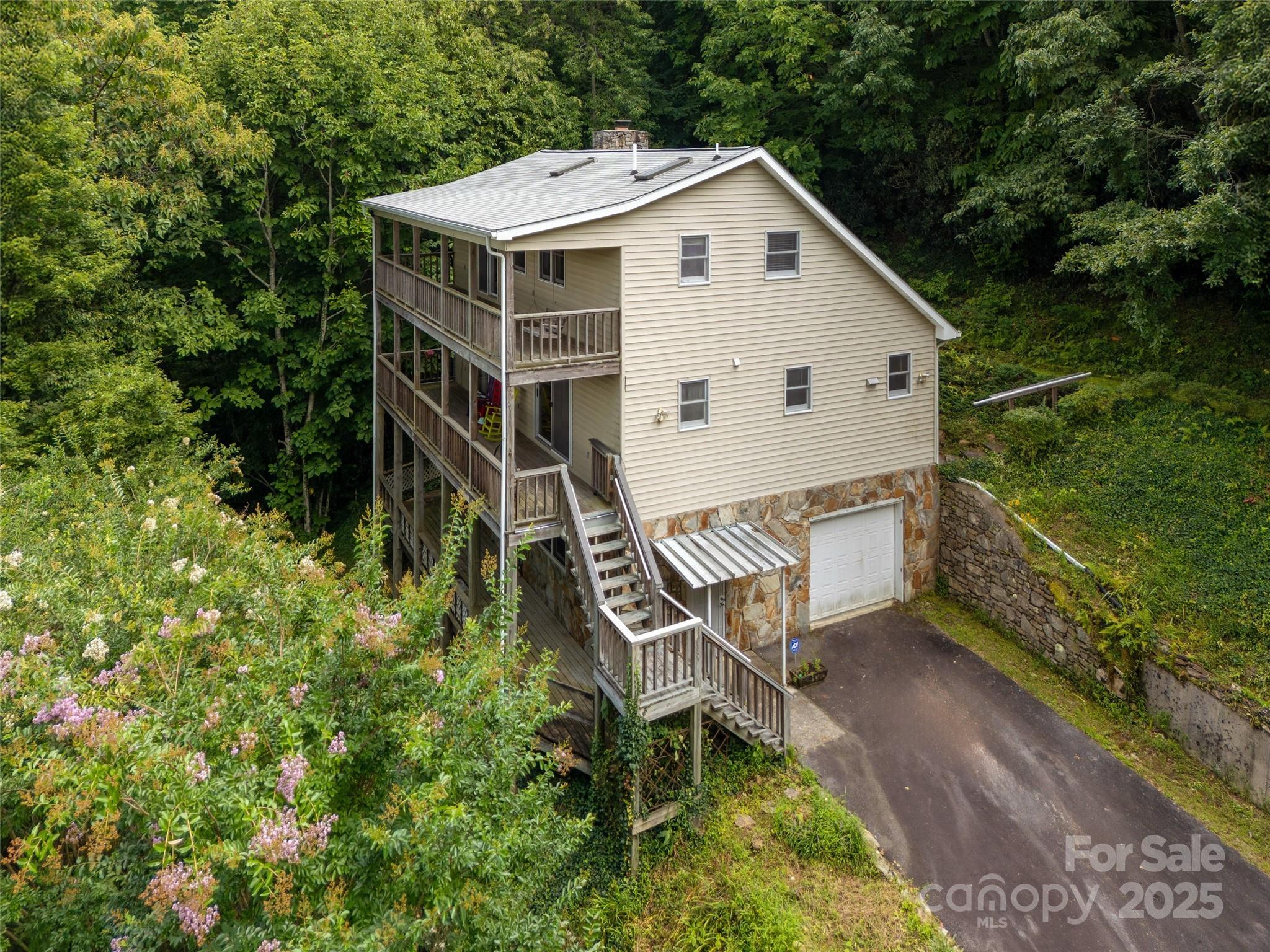 Wonderful mountain retreat on approximately 4.5 acres. Spectacular long range year round views from two large covered decks. Large open plan on main level and two loft bedrooms upstairs. Hardwood floors, stone fireplace, vaulted ceilings all make this a perfect get away home in the mountains. Full unfinished basement with a half bath plus a one car garage. Narrow, steep, paved access from the private gravel road. No HOA but a road maintenance agreement in the deed. Two lots, to be sold as one. The house is on Lot # 12 that is 2.14 Ac.  Lot 10 is 2.34 . Will be deeded as one lot.