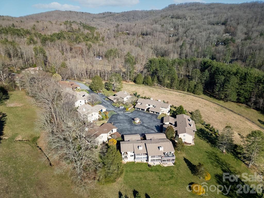 This Glen Cannon condo offers comfortable mountain living with beautiful views in a convenient Pisgah Forest location. The unit features single-level living with 2 bedrooms and 2 baths, an open floor plan with a fireplace in the living area, and an oversized screened-in porch perfect for enjoying the peaceful surroundings.

Extensively updated, the home includes new flooring, kitchen appliances, interior paint, and numerous additional improvements throughout. Major upgrades provide added value and peace of mind, including a brand-new roof installed this past fall, along with new carport and front stair carpeting and other thoughtful enhancements.

An attached carport provides covered parking with dedicated storage. The additional space in the basement adds valuable flexibility with finished living space, a bathroom, and storage, ideal for guests, hobbies, or a home office. Large windows bring in natural light and highlight the scenic setting.

Located just minutes from Brevard, outdoor recreation, dining, and all that Transylvania County has to offer, this move-in ready condo blends modern updates, low-maintenance living, and mountain charm—perfect as a primary residence, second home, or lock-and-leave retreat.