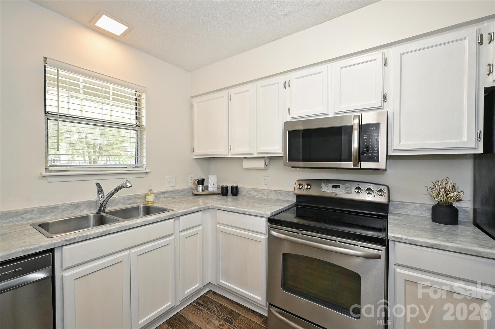 Welcome to Heathstead Place, a popular SouthPark community offering low-maintenance living in an unbeatable location. Freshly painted throughout, this updated two-story condo features new carpet on the stairs and upper level, plus a refreshed kitchen with new countertops and a new dishwasher. The main level offers luxury flooring, a dining area, a living room with a wood-burning fireplace and a convenient powder room. There is also space in the kitchen for a stackable washer and dryer.

Upstairs, the loft-style bedroom includes a large closet, shelf storage, and an updated bath area with a new light fixture and mirror.

Enjoy private outdoor living with a fenced patio area, perfect for relaxing, entertaining, or container gardening.

Additional updates include a newer AC system installed in 2024. Community amenities include a clubhouse and outdoor pool.  HOA dues include water.

Located in the heart of SouthPark, this home offers one dedicated parking space plus lots of extra parking, easy access to shopping, dining, grocery stores, parks, and everyday conveniences. Walk to the Harris Y and Beverly Woods Elementary School!  Great opportunity for a primary residence or investment property!