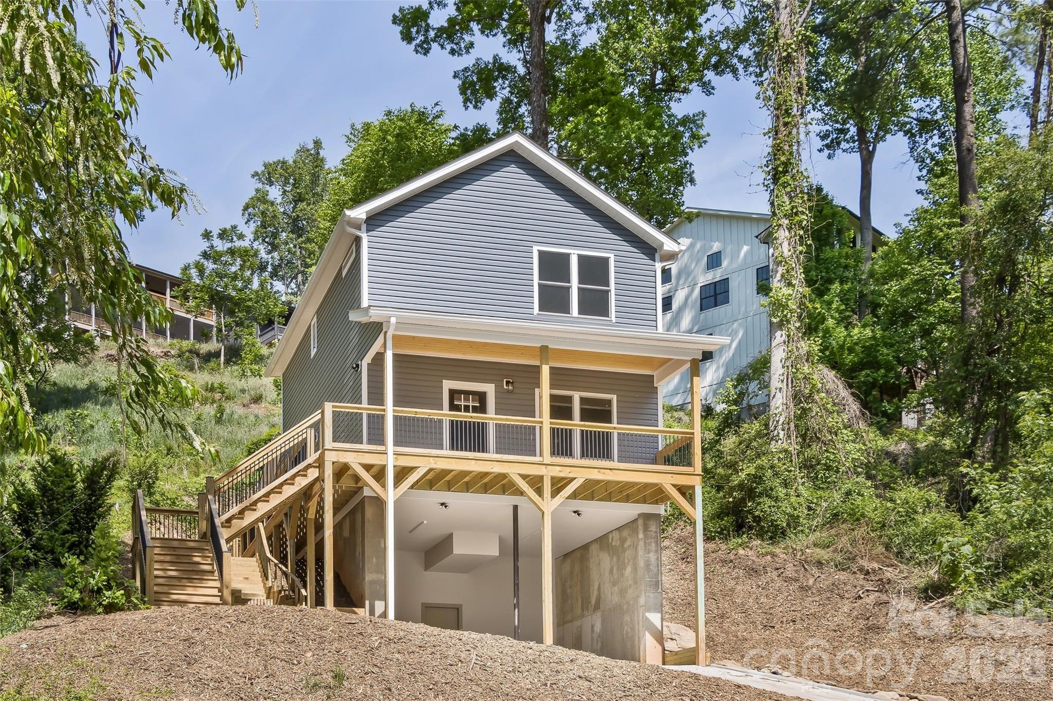 Come check out this New Construction in the heart of Biltmore Area with an incredible floor plan. This BRAND new home offers 3 bedrooms, 2 1/2 bathrooms plus an open concept living room, kitchen, dining . When you walk in, you'll find high end finishes such as granite counters, stainless appliances, LVP flooring throughout and tile in the bathrooms. Nine foot ceilings downstairs and eight foot ceilings upstairs. The large covered front porch is perfect for relaxing. Back deck is located just off the kitchen, with a walk way to front porch. Very convenient to downtown Asheville, Biltmore area. Shopping just around corner.  Covered parking for 2 vehicles plus 3 additional spots on driveway. Close to the Tobacco Barn Antiques