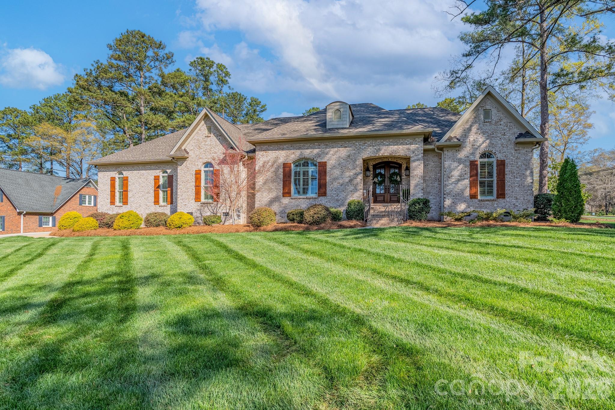 Your list is going to be checked off when you see this custom-built, one-level, all brick classic that is ready to welcome new owners.  From the covered front entrance to the manicured lawn, you will be impressed!  The open plan with engineered wood flooring is perfect for entertaining with a chef’s dream kitchen featuring stainless appliances, including gas cooktop with hood, double wall oven, French door refrigerator, and quartz countertops.  A large island with seating and farm sink provides gracious counter and storage space. The tongue-and-groove wood ceiling brings warmth and charm to the kitchen and breakfast area.  The family room, with gas log fireplace and built-ins, is both cozy and welcoming to guests.  A beautiful dining room is the perfect place for dinner parties or family meals.  The primary bedroom suite includes a private spa-like bath with tiled shower, free-standing soaking tub, double sink vanity with quartz, and a large primary closet (11’ x 12’) with a storage island.  Two additional bedrooms share a bathroom, each with their own sink, vanity, and built-ins.   The powder room and large laundry room with cabinets and stainless sink complete the home.  All windows have either plantation shutters or custom shades, making your decorating so much easier.  A special feature is the screened porch with brick wood-burning fireplace that is the perfect spot to relax or gather with friends.  A small patio is ready for your grill and/or lounge chairs.  The double garage, with epoxy flooring, includes a natural gas installed heater that provides a warm place to work or the perfect overflow entertainment space.   Needing storage room?  Check out the walk-up unfinished space over the garage with access from the laundry room.  In addition, the home is equipped with a tankless water heater and irrigation system. Located on a corner lot in the Heathwood neighborhood, 677 Rutledge Avenue is going to entice you!