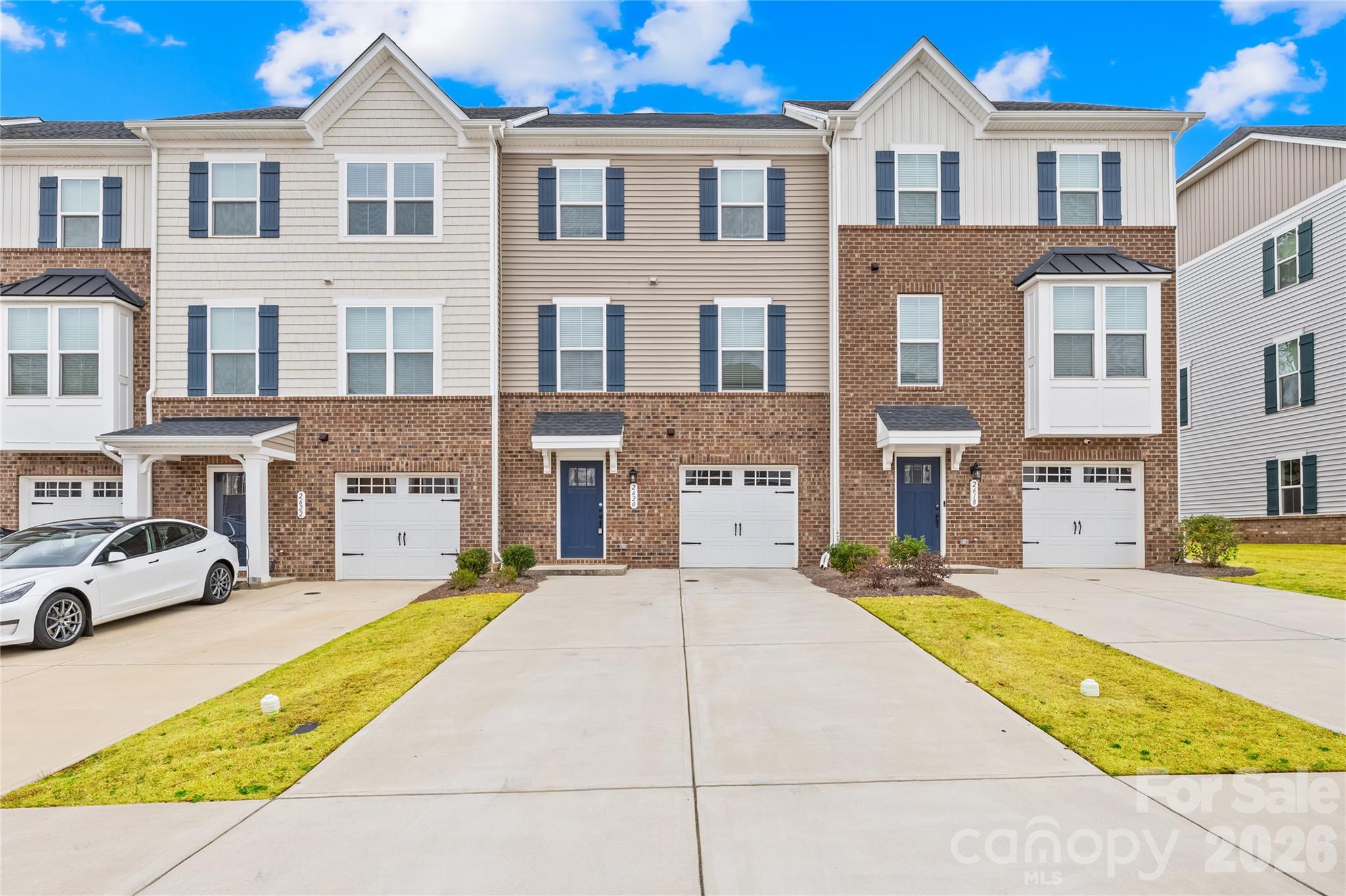 Beautifully maintained, like-new 3-story townhome in the desirable Grantham Place community in Fort Mill offering approximately 1,820 sq ft of functional living space with 3 bedrooms, 2 full bathrooms, 2 half bathrooms, and a front-entry one-car garage.

The entry level features a versatile flex space ideal for a home office, workout area, media room, or additional living space along with convenient garage access. The main living level offers a bright open-concept layout with abundant natural light, spacious living and dining areas, and a modern kitchen featuring quartz countertops, stainless steel appliances, gas range, pantry, and ample cabinet storage. Step out onto the private deck directly from the dining area, perfect for relaxing or entertaining. A convenient half bathroom is also located on the main level.

Upstairs, the spacious primary suite features a walk-in closet and private bathroom, while two additional bedrooms, a full bathroom, and laundry area complete the upper floor.

Enjoy resort-style community amenities including a swimming pool, tennis courts, pickleball courts, playground, clubhouse, and more. Conveniently located near Baxter Village, Kingsley, Historic Downtown Fort Mill, Harris Teeter, shopping, dining, and with easy access to I-77 and nearby Ballantyne, Pineville, Indian Land, and Charlotte.