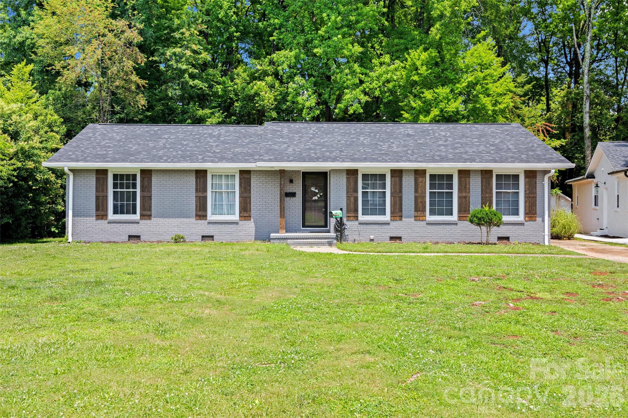 Step into a beautifully renovated 3-bedroom, 2-bathroom home set on a sprawling, tree-canopied lot in one of Charlotte's most desirable pockets. Light pours through the open floor plan, where every room flows easily into the next, anchored by a warm fireplace built for cozy evenings. The kitchen and bathrooms are finished with rich quartz countertops, polished premium fixtures, and spa-inspired tilework that turns everyday routines into something closer to a retreat. Originally built in 1960 and renovated from top to bottom, the home blends solid mid-century bones with thoughtful, high-end updates throughout. This home offers a rare combination: peaceful seclusion just 10 minutes from the energy of Uptown Charlotte, and a quick 5-minute drive to SouthPark Mall's shopping, dining, and entertainment.