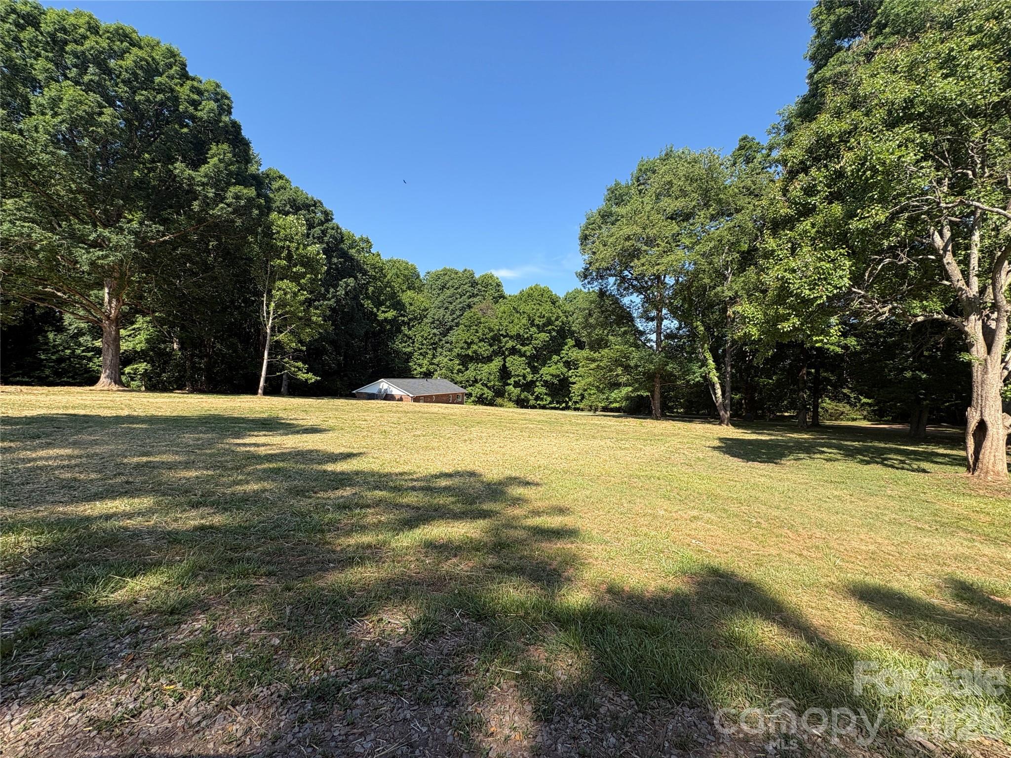 This newly renovated home sits on over 9 acres in the desirable Cool Springs and Northern Iredell area! This is a great ready to move into starter home, perfect for short-term living while you build your dream home, or use as an in-law suite, guest house, or even convert it into a detached She-Shed or Man Cave. The property features beautiful, cleared areas for pasture or building sites, mature trees, and a long, private gated & gravel drive. Enjoy total privacy in this deer and wildlife haven! Bring your hobbies and ATVs. Zoned R20, no manufactured homes are allowed. The seller permits re-subdividing the lot twice to preserve the area’s quality & 1500+ sq ftg considerations that can be discussed and potentially negotiated. Maintaining the quality of the immediate area, especially for the neighbors, is important to seller... Conveniently close to Statesville’s charming downtown with unique restaurants and shopping, and just minutes from the I-77 & I-40 interchange. Excellent location—30–40 minutes to Charlotte, Winston-Salem, and Hickory, and approximately 1 hour to Boone, NC, and the stunning Blue Ridge Mountains!  New Roof 2025! Recent HVAC installed.