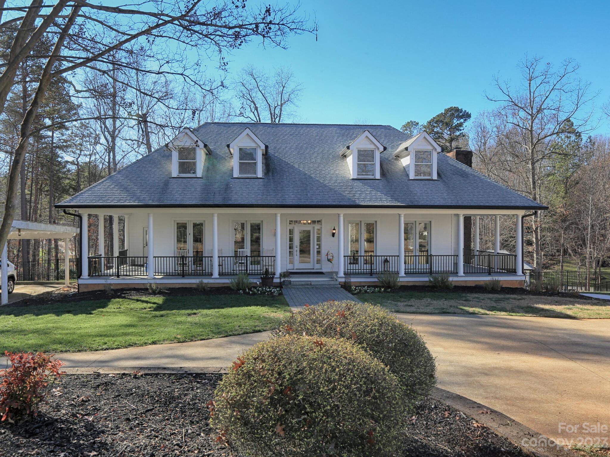 Incredible opportunity to own this beautifully updated home on 2.62 acres with a covered boat slip, pool, hot tub, outdoor fireplace, apartment over 2 car garage and so much more! This home has everything you could dream of! Curb appeal, covered wrap-around porches, refinished real hardwood floors, and a kitchen fit for royalty. Built-in refrigerator and built-in freezer, gas range with double oven, soft close cabinets, pull-outs, prepping area, second sink, second dishwasher plus cabinet and counter space galore! And it is oh-so-pretty! The main floor living includes formal and informal dining plus a huge open living room with a fireplace flanked by built-in shelves. Upstairs find 4 bedrooms and 3 full baths. The updated luxurious bathrooms are must-sees! The basement offers a guest room, full bath, exercise room, and recreation room. Step outside and enjoy the private backyard amenities. Don't miss the man-cave apartment over the garage- great for guests or renting. No HOA!