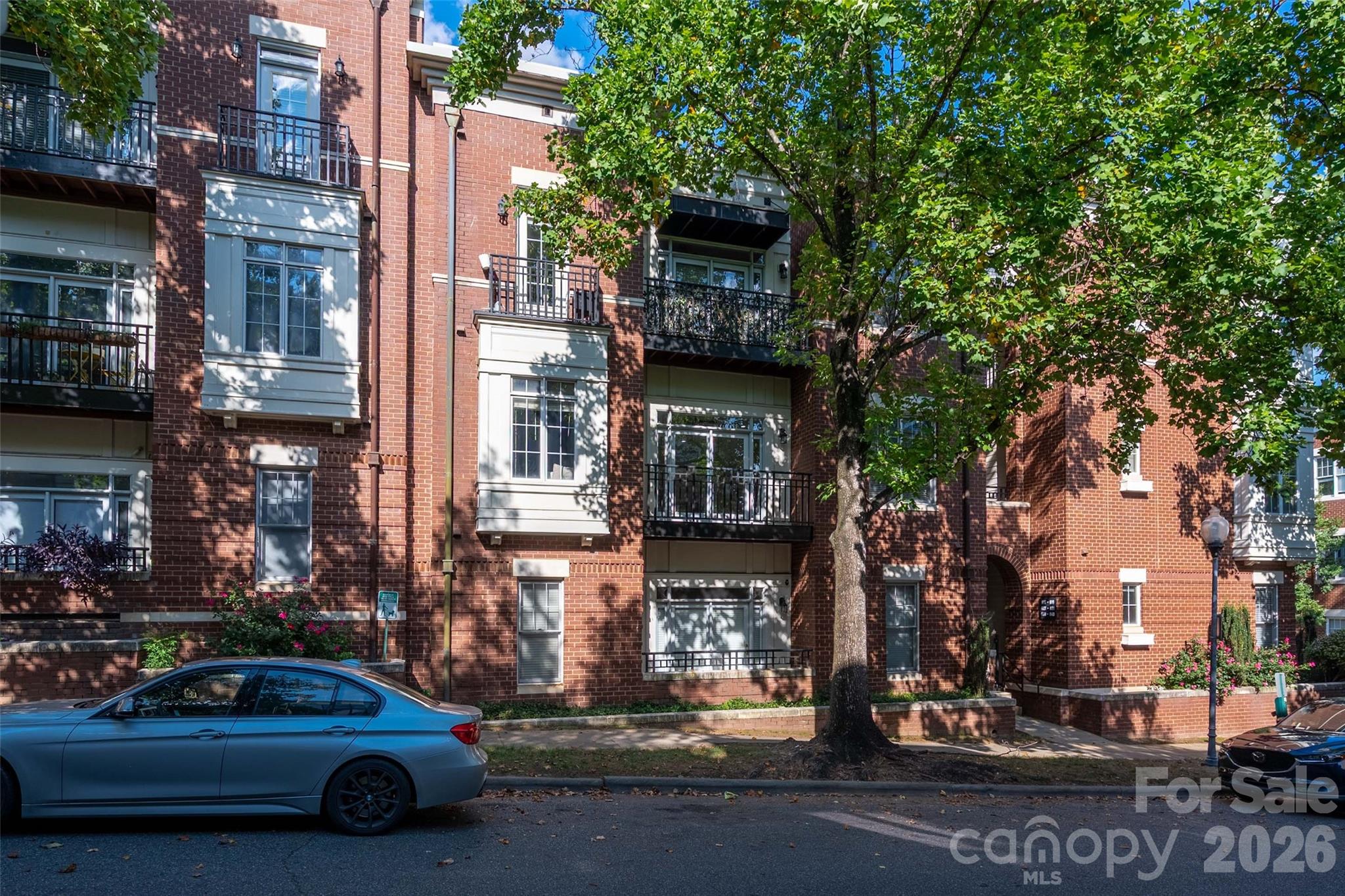 Public Remarks 
Discover the perfect blend of convenience and neighborhood charm in the heart of Charlotte's vibrant First Ward! This unit puts you steps away from the Queen City’s best dining, shopping, theaters, and nightlife. Step inside to soaring ceilings with fresh paint and new LVP hardwood flooring that create a warm, welcoming feel. The open-concept living and kitchen area maximizes space and flow, with a sleek island offering additional seating for casual meals or entertaining. The kitchen shines with granite countertops, tile backsplash and plenty of prep space. The spacious primary suite features a walk-in closet and a private bath with granite countertops, dual vanities & tile floors. The secondary bedroom, perfect for guests or a home office, enjoys access to a full hall bath with matching granite countertops & tile flooring. A full-size stackable washer and dryer are included for your convenience. Outdoor enthusiasts will love being just a short stroll from the Little Sugar Creek Greenway, while city lovers can walk to Charlotte’s iconic bars, restaurants, and cultural destinations. Airbnb potential. No short term rental (STR) restrictions. CCRs/Bylaws show only a 7 day rental restriction!!
