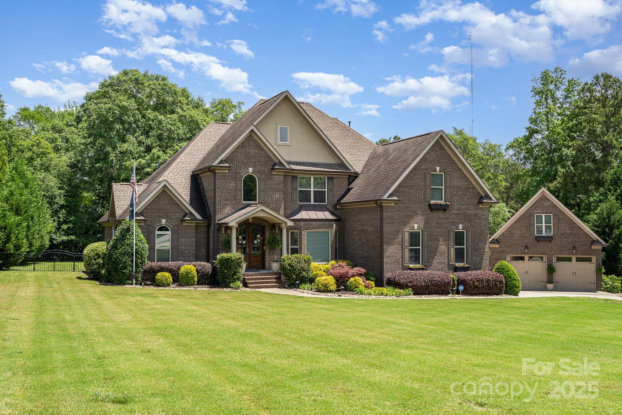 Peaceful and relaxing, this upgraded and immaculate 2 story transitional home sits on 1.81 Acres of waterfront land. Finely crafted with architectural upgrades: cathedral ceilings, arches, gourmet kitchen, hard wood floors, fireplace, granite counters & soft close cabinetry show the quality within. Flex space / playroom is centrally located to meet your needs. Generous windows and French doors let you enjoy the natural landscape from any room. Detached garage is ideal for workshop or vehicles. Second level is perfect for additional storage. Great for Entertaining: yard with fire pit is fenced in and extends beyond the footbridge to a waterfront retreat by the pond. Upgrades include: Crawlspace encapsulation, Rinnai Tankless Water Heater, Mitsubishi Ductless cooling units & Trane HVAC. Prime Location:Just 10 minutes from major shopping, top-rated schools, and only 35 minutes to Charlotte and the airport, this property offers the perfect blend of seclusion and accessibility.