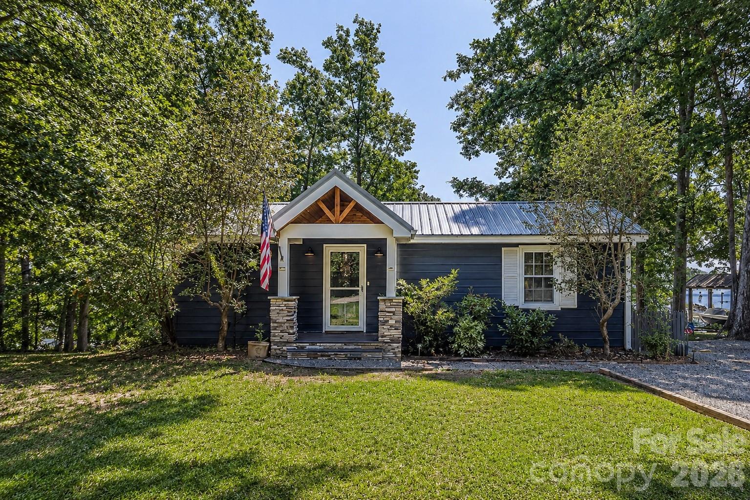 Rare Lake Norman waterfront opportunity with no HOA! Welcome to The Cottage on Osprey Cove, a beautifully renovated 2-BR, 1-BA retreat offering 150 ft of prime shoreline and a spectacular year-round, 1-mile water view. Situated on a beautiful lot on Kiser Island, this move-in-ready cottage blends 1966 classic charm with modern updates, featuring pristine hardwood floors, a 5-year-old roof & HVAC, and stunning sunrises from the living room and primary bedroom.  

The ultimate outdoor lifestyle awaits on the expansive screened porch and open grilling deck. Boaters will love the 30 ft floating dock with boat slip, water, and power—offering deep, year-round water even at lowest lake levels. The property features exceptional expansion potential. lake-fed irrigation, 360-degree security, and ample parking for an RV/boat trailer. Enjoy quiet, peaceful living but also only minutes from dining, shopping, and top-rated schools.