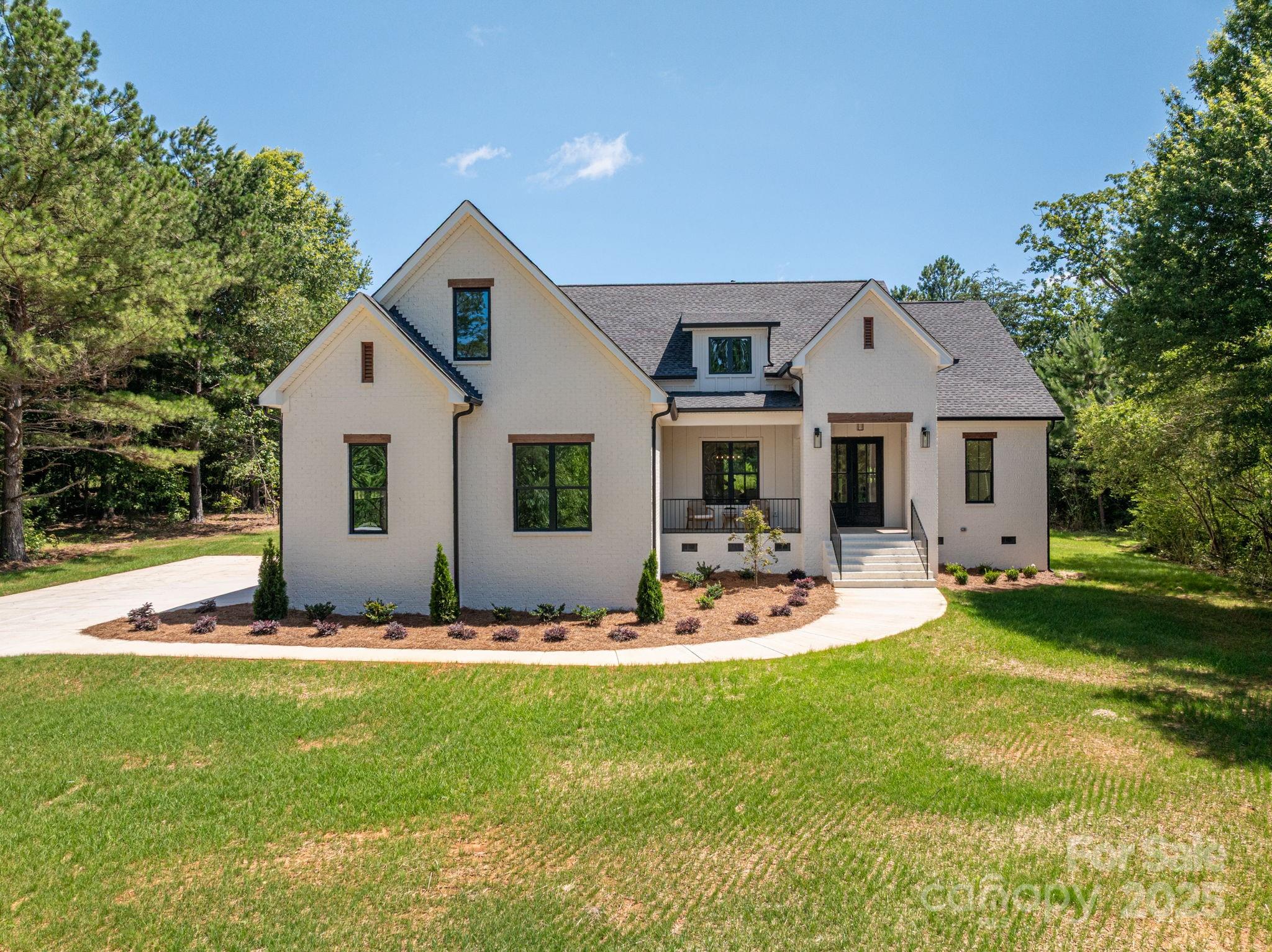 Welcome to 1062 Sage Pine Cir, a modern farmhouse on 1.15 acres in the heart of Clover—where thoughtful design, quality finishes, and everyday comfort come together. This newly built home features high ceilings and a bright, open layout anchored by a stunning kitchen with quartz countertops, Kitchenaid appliances, and an oversized island that flows into a casual dining space. The main level offers a spacious primary suite with a trey ceiling and luxury spa-like bathroom, plus two additional bedrooms and a beautifully appointed full bath. Upstairs, a versatile bonus room with full bath makes the perfect guest suite, media space, or teen retreat—alongside a large walk-in attic offering valuable storage or future expansion potential. Outside, enjoy privacy and room to grow, with no rear neighbors and a peaceful, established setting. All just a short walk to downtown Clover and top-rated schools—with the added bonus of low South Carolina taxes.