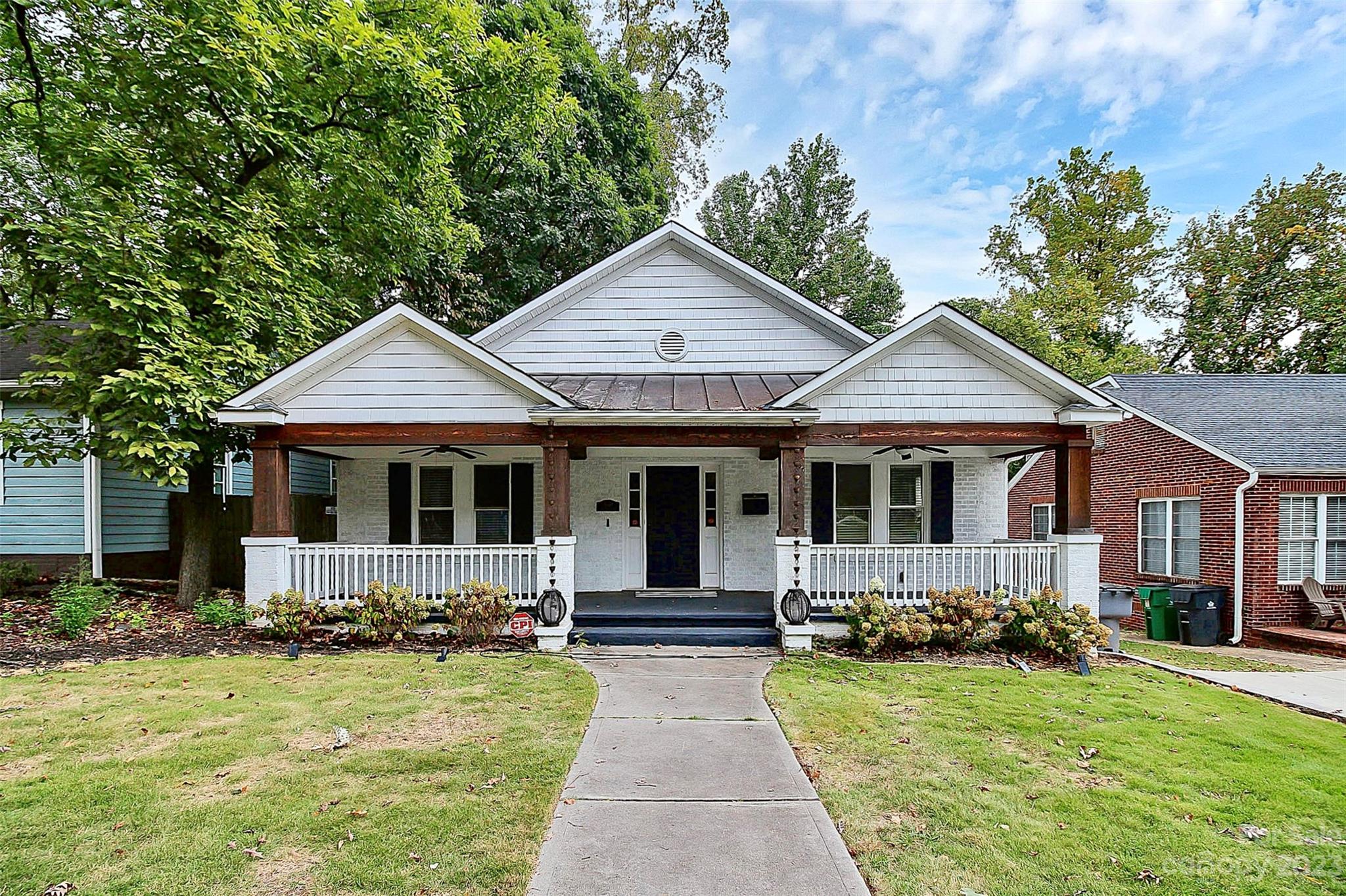 Historic Wilmore home oozing with charm + character! Your elongated, covered front porch makes the ideal spot to enjoy your morning coffee or evening cocktail. Once inside, your eyes are immediately drawn to the stunning hardwood flooring flowing throughout the open concept main entertaining spaces. With a living/sitting room & dining area open to your beautiful kitchen, hosting dinner parties or entertaining family + friends is a breeze here. Your primary oasis features a breathtaking wood accent wall, & includes a large walk-in closet + en-suite, complete w/ a soaking tub & stand-alone shower. The secondary bedrooms are sizable w/ natural light pouring in the windows & all the bathrooms have been updated to fit modern living. Out back, you'll enjoy dinners outside under the stars on your massive back deck overlooking the fully fenced in yard. Don't miss out on your chance to own this well kept + updated historic home, situated close to all that South End + Uptown have to offer you!