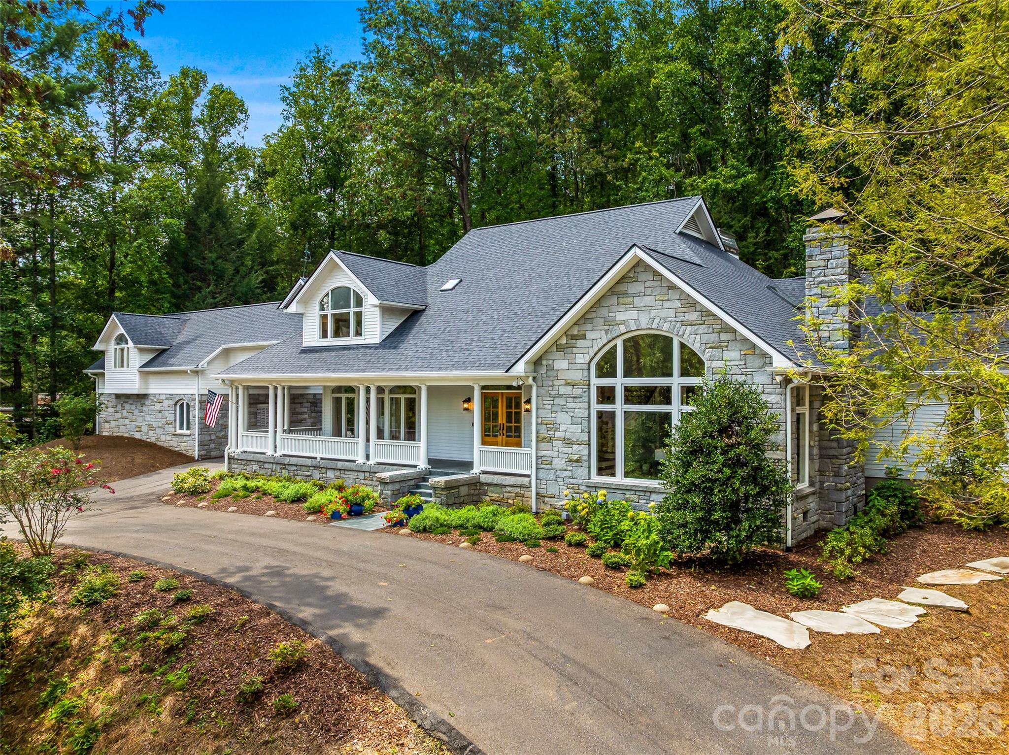 Amazing opportunity to move into a fully renovated home in this coveted historic neighborhood. Grand sized living spaces have been meticulously updated with the finest of cabinetry and finishes in neutral palettes so that you can enjoy your new home from day one. The main floor of over 3700 square feet offers gracious one floor living. Enjoy the rocking chair front porch with it mountain view or cozy up by the stone fireplace on the rear terrace. Upstairs you will find ancillary bedrooms and baths plus an office. A guest or multigenerational apartment which has both an interior and exterior entrance has a studio bedroom/ living area, a laundry, a full bath and a complete kitchen with a breakfast area. Ideal for relatives, an au pair, staff or friends it can be used as stand alone or connected space. On the basement level is a recreation room and a half bath plus great storage. The home is constructed of 
 massive blocks of granite and frame and was built for the ages but designed for today. If your dream of Biltmore Forest living includes a virtually new home ready for you today don't miss this rare opportunity.