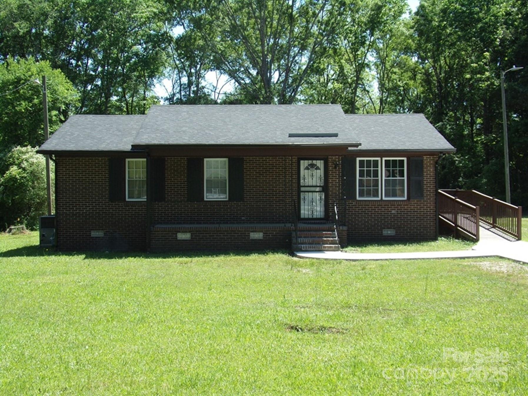 New Paint and Flooring make this 3 Bedroom Brick Ranch shine.  There is a new concrete driveway and sidewalk to the front steps.  Bedrooms are nice sized with good closet space.  The lot is level with large backyard. The large bathroom includes the washer that stays, and a dryer hook-up.  Kitchen cabinets have fresh paint, and countertops have been updated.  The refrigerator also stays.  Dining area open to Kitchen.  The living area is inside the front door.  New metal storm doors and fresh blinds.  Functional storm shutters added to outside.  A new wheelchair ramp was added.  Water heater is in attached storage shed with plenty of space.