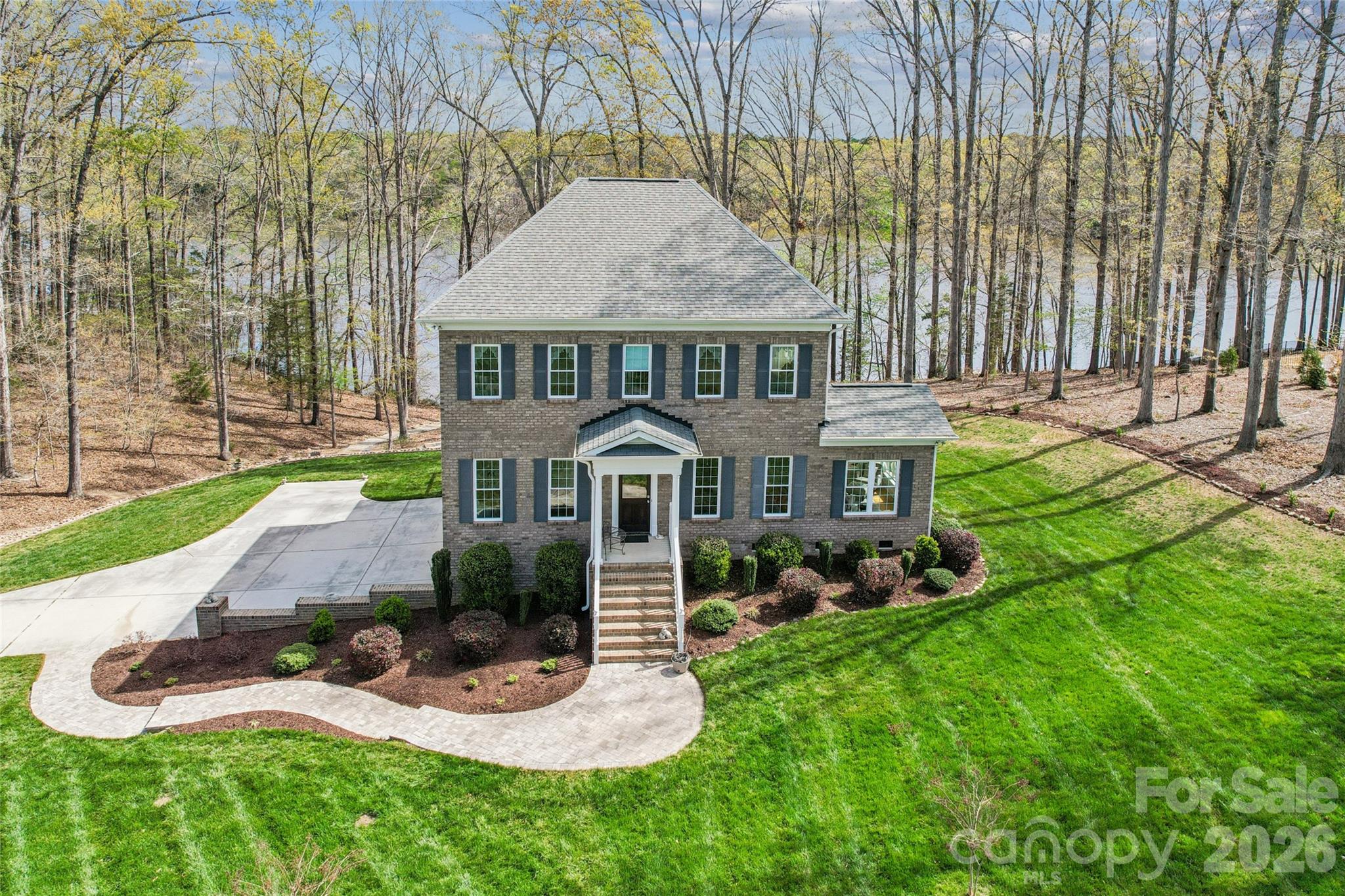 Meticulously maintained lakefront home that presents like new construction on Lake Lee in Monroe, NC. Perfectly positioned on 1.80 acres with over 200 ft of water frontage, this exceptional 4-bedroom, 3-bath home offers a rare opportunity to own a thoughtfully designed custom built home on lakefront property. Immerse yourself in nature just outside the Charlotte area with beautiful views, peaceful surroundings, and wildlife, including deer, eagles, and turtles. From the moment you enter you are welcomed by hardwood flooring, elegant moulding, an abundance of natural light, and sweeping lake views that create a calm and inviting atmosphere throughout the home. The bright, open kitchen is ideal for entertaining and features quartz countertops, mosaic tile backsplash, KraftMaid cabinets, and stainless steel appliances, including a KitchenAid gas range and microwave drawer. The kitchen flows seamlessly into the main living areas, sunroom, and expansive back deck overlooking the lake, perfect for enjoying morning coffee or evening sunsets. The flexible floor plan includes a dedicated study or office that can easily function as a fourth bedroom, conveniently located near a full bath on the main floor featuring a tile walk-in shower and a quartz freestanding vanity. Upstairs, the spacious primary suite offers a beautifully appointed bath with a new designer walk-in shower, double-sink quartz vanity, and space to add a freestanding soaking tub for a spa-like retreat, along with two closets-one being a walk-in for all your wardrobe desires. The second level also features two additional bedrooms, with large closets and a full bath with double-sink quartz vanity. Outside enjoy a private paver walkway leading directly down to the lake, a sitting area, deck, all alongside a large two-car side loading basement garage that provides ample storage for both everyday living and outdoor lifestyle enjoyment. Conveniently located just a short drive to quaint revitalized downtown Monroe, I-74, shopping, and nearby medical facilities, along with several public, charter and/or private school options are also within a reasonable distance. Please visit City of Monroe for more information on Lake Lee.
