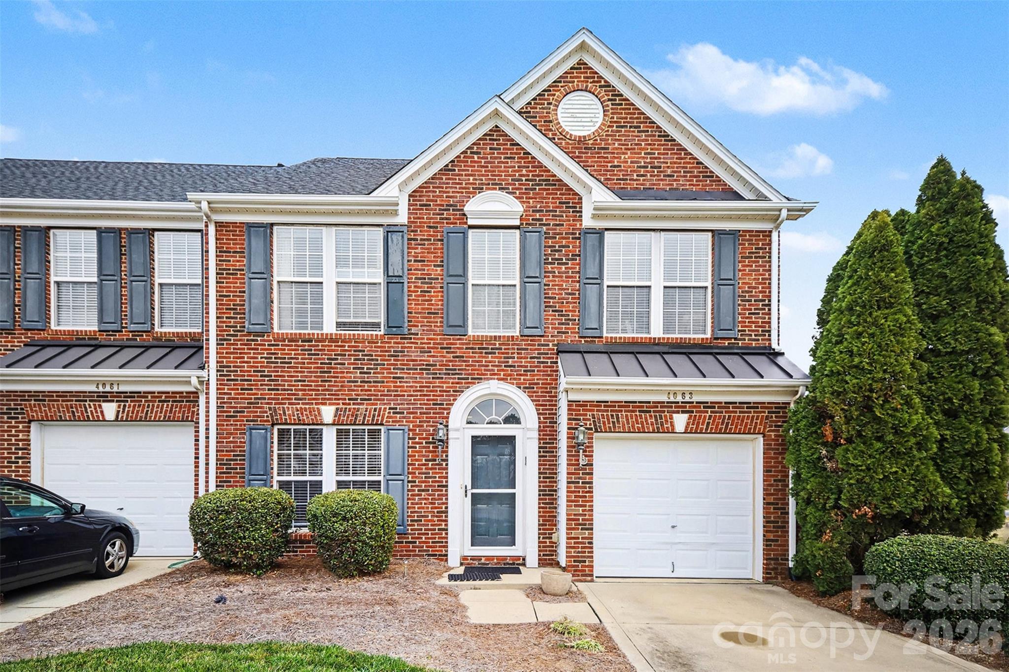 Beautifully bright end-unit brick townhome with open living area & private fenced-in backyard. Home opens up with entryway and formal dining room on the left. Hardwood floors flow throughout main level into living area flooded with natural light from a full wall of windows including sunroom space / breakfast nook. Kitchen has breakfast bar seating option,  New (2022) updated S.S appliances including gas range, plus tons of cabinets and pantry for storage. Upstairs the primary bedroom suite has tray ceiling and walk-in closet plus attached full bath partially renovated in 2023 including dual sinks, stand-up glass shower, and soaking tub. 2 additional bedrooms plus beautifully fully renovated (2023) full hall bath perfect for family & friends. Enjoy grilling out on the back patio in the spacious backyard and beyond that enjoy the large playground and community pond with walking trails around it. Behind the unit is spacious green space ensuring ultimate privacy - all perfectly situated between Indian Trail & Monroe. UPDATES INCLUDE: 2022 new roof & entire home flooring + S.S appliances. 2023 - Chandeliers & blinds + guest bathroom & primary bathroom.