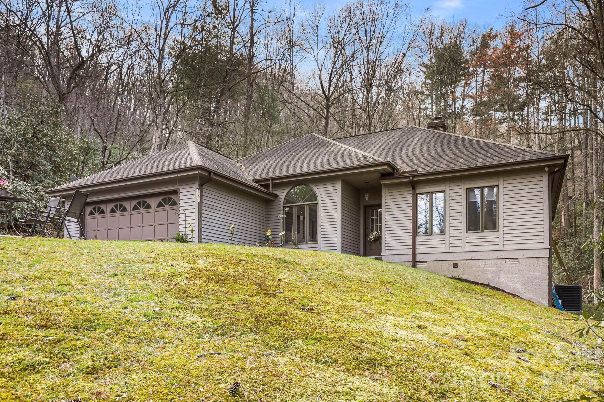 Welcome to 446 Silver Fox Lane, a charming and thoughtfully designed home nestled at the end of a quiet cul-de-sac in the highly sought-after Fox Crossing community of Pisgah Forest. Set on a private lot, this property offers the perfect combination of peaceful mountain living and everyday convenience. Inside, you’ll find a bright, open living space highlighted by vaulted ceilings and large windows. The split-bedroom floor plan provides ideal separation, with a spacious primary suite tucked away for privacy and comfort. Two additional bedrooms offer generous space for guests, family, or a home office. The home is designed for easy one-level living, featuring low-maintenance finishes, an attached garage, and a flat driveway for effortless access. Step out back to enjoy the private deck—perfect for morning coffee, evening relaxation, or entertaining while surrounded by nature and tucked away in your own oasis. Located just minutes from Pisgah National Forest and DuPont State Forest, outdoor adventure is always within reach. You’re also just a short drive to downtown Brevard, where you can enjoy local dining, shopping, and a vibrant small-town atmosphere. Whether you’re looking for a full-time residence or a peaceful second home, this property offers comfort, privacy, and an unbeatable location.