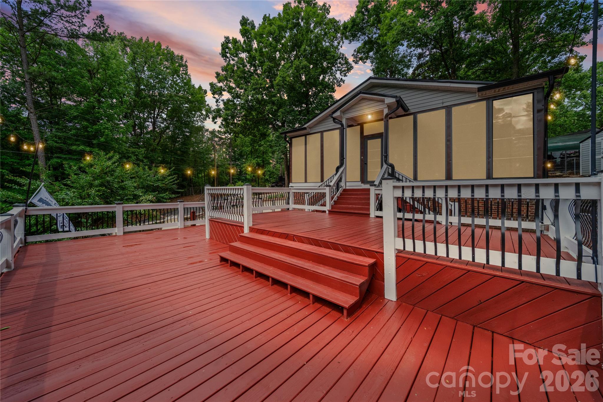 LIVE THE LAKE LIFE WITHOUT BREAKING THE BANK! You'll want to see this one, it's a STUNNER! A unique, well-maintained charmer that is truly move-in ready. Freshly painted & tasteful throughout, large open living room, 2 cozy bedrooms, updated bathroom and a spacious kitchen/dining room. Need more space? You got it! With it's huge, enclosed climate-controlled sunroom and Eze-Breeze window system for year-round living, space is NOT an issue. Love outdoor living? This is the spot! You'll appreciate the gorgeous landscaping, fountain water feature, a custom 750+ Sqft deck for all your entertaining, grilling or relaxing needs with space left for your own outdoor ideas. All the boxes are checked! Freshly painted deck, NEW 6 inch gutters, NEW insulation in ceiling over sunroom, NEW metal roof & flooring for storage building, NEW space saver Samsung microwave, NEW sewage pump/check valve, HVAC and mini split recently serviced in 2025, washer/dryer and water heater less than two years old. All this perched on a double corner lot in the PRIVATE gated Lake community of Twin Harbor. Lake access, private beach, Community pool, boat storage, Game courts, NEW pickleball court, picnic area, playground, year-round entertainment....you name it! It even has its own restaurant & grocery store so you never have to leave! Whether you make this gem your vacation getaway, weekender or primary residence, you won't be disappointed. It's time to buy a boat! Welcome Home!  (Professional pictures to come. Stay Tuned!)