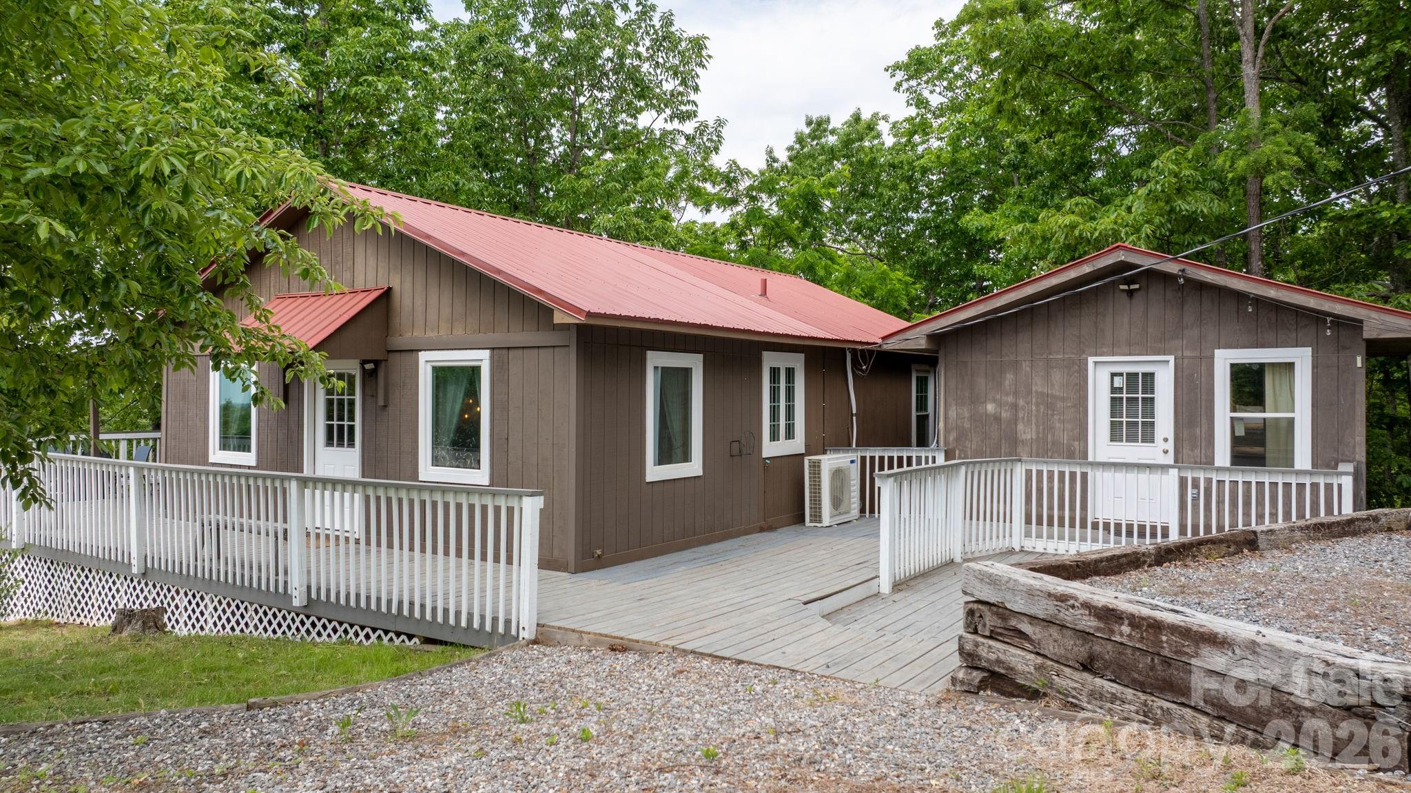 Tucked away in a remote gated mountain community, this unique property offers the perfect blend of privacy, peace, and endless possibilities. Set on 0.74 acres and including 5 additional buildable lots for a total of 4.21 acres, this rare opportunity gives you room to expand, invest, or simply enjoy your own private mountain retreat.
The property features a beautifully rustic main cabin with 2 bedrooms and 1 full bath, complete with a cozy fireplace that creates the perfect mountain-living atmosphere. A separate additional living space offers 1 bedroom and 1 full bath, ideal for guests, multi-generational living, or income-producing rental potential. A versatile shed on the property could easily become a studio, workshop, gym, playhouse, sauna, or extra storage space — the possibilities are truly endless. The spacious deck is also perfectly suited for adding a hot tub and creating your own relaxing outdoor oasis.
Surrounded by nature and mountain views, you’ll love spending evenings on the large partially covered wraparound deck or gathering around the fire pit under the stars. Enjoy the peaceful wooded setting and experience true mountain living at its finest. The community also features an inground pool, clubhouse, and picnic area, all overlooking breathtaking views from approximately 2,500 feet in elevation.
Adventure is always close by with South Mountain State Park and Lake James State Park just minutes away, offering hiking and biking trails, lake beach access, swimming, boating, fishing, and picnicking. Downtown Morganton is also nearby for local shopping, dining, and entertainment.
Whether you're looking for a full-time residence, vacation getaway, short-term rental investment, or a combination of all three, this mountain property offers a lifestyle and opportunity that’s hard to find.