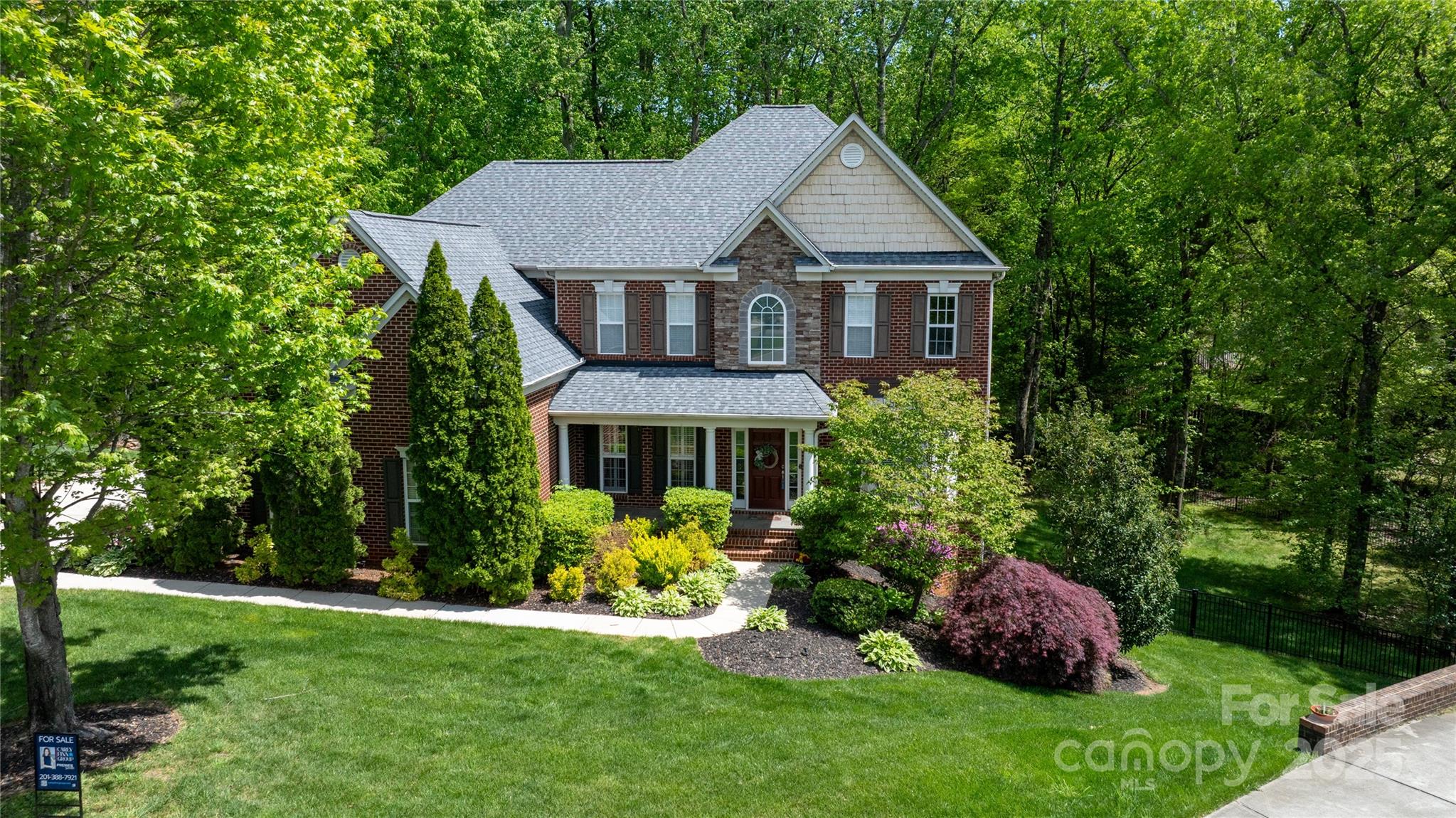 Welcome home to this simply stunning and blissful backyard oasis, complete with a new composite deck with a screened-in porch, brick patio and a fireplace. Step inside to discover 6 beautifully appointed bedrooms, 4.5 baths, and a serene main-level primary suite with floor-to-ceiling windows framing a stunning backyard view.  Soaring ceilings, custom built-ins, and a spacious kitchen make entertaining a breeze. Upstairs boasts a sixth bedroom/flex space and a large bonus room ideal for work, play, or storage. The finished basement includes a kitchen, bedroom, & bath—perfect for guests or multigenerational living. Upgrades include: roof ('21), refinished hardwoods and new upstairs flooring ('22), Renewal by Andersen windows ('23), raised garden beds ('24), updated HVACs (3), and a new 75-gallon water heater. The fenced backyard is perfect for kids, pets, or relaxing evenings outdoors. The home is located in the highly desirable and well-managed Laurel Park Subdivision.