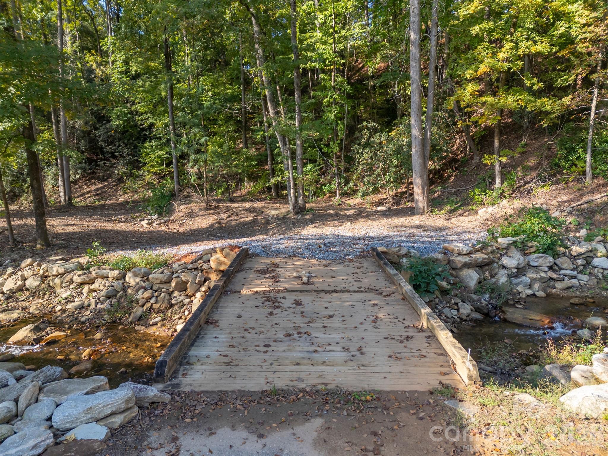 Discover a rare opportunity to own a private, creekside homesite in the highly sought-after gated
community of Firefly Cove in Lake Lure. Lot 9 offers a stunning natural setting and a year-round
stream creating a peaceful mountain retreat. Firefly Cove is known for its upscale charm and natural
beauty. Community amenities include a gated entrance, a beautiful clubhouse, a swimming pool with
views of Lake Lure, fitness center and lake access for swimming, boating and fishing. Conveniently
located just minutes to Chimney Rock and Lake Lure, and approximately 1 hour to Asheville, 1 hour 15
minutes to Greenville and 1 hour 45 minutes to Charlotte. Ideal for primary residence, vacation home.