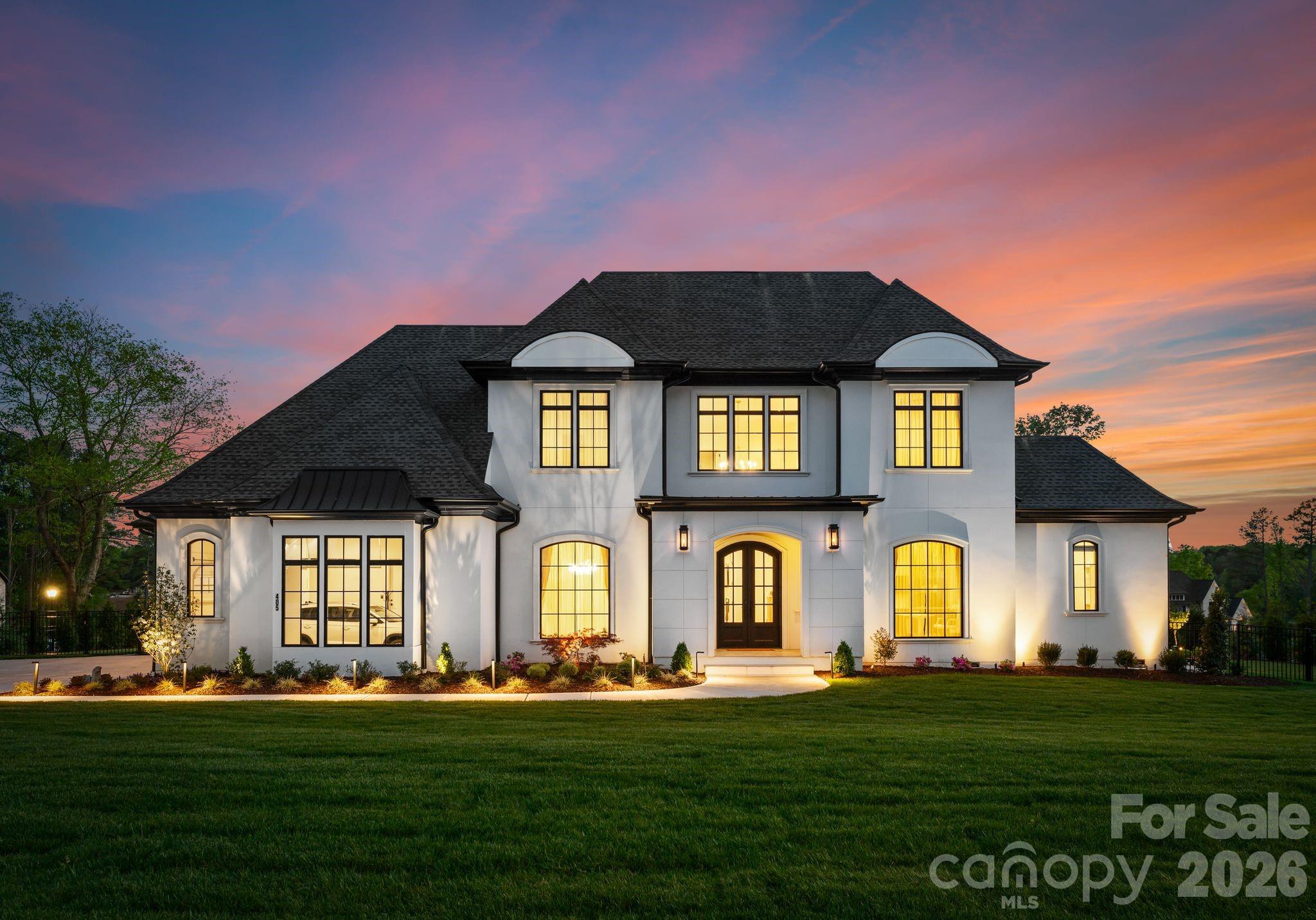 Discover elevated living in this custom-built North-East facing home, located in Twin Lakes—Weddington’s newest luxury lakefront community. Blending timeless sophistication with modern comfort, this home is thoughtfully designed for both refined living and effortless entertaining. Enter through grand double doors into a dramatic two-story foyer with a sweeping staircase, setting the tone for the open-concept layout made to impress. The main-level primary suite offers a serene retreat with spa-like finishes, while the chef’s kitchen—featuring high-end appliances, designer cabinetry, and a hidden scullery—combines beauty with function. Upstairs, you’ll find three spacious en-suite bedrooms and a versatile bonus room, ideal for family living or guests. An additional 800 sqft of unfinished space allows for more bedrooms if needed. Located in a top-rated school district and minutes from Waverly’s premier shopping and dining, this home delivers luxury, location, and lifestyle all in one.