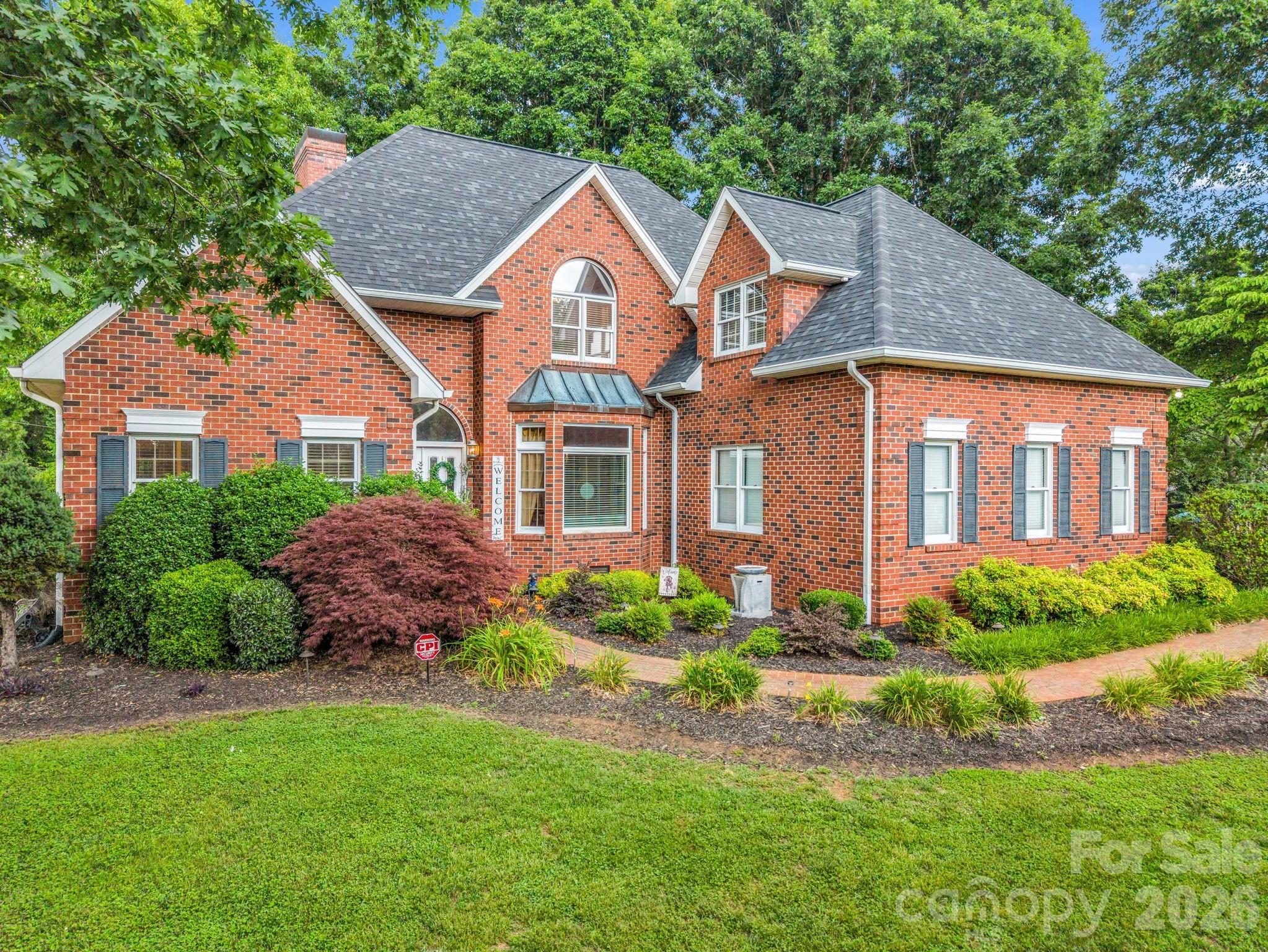 Welcome to this beautifully maintained brick home, where timeless craftsmanship and
modern convenience come together to create an exceptional living experience. Thoughtfully
designed and meticulously cared for, this residence offers spacious living areas, quality finishes,
and inviting indoor and outdoor spaces. The attached two-car garage provides direct access to a well-appointed kitchen featuring custom cabinetry, granite countertops, and a center island perfect for food preparation. Just off the breakfast nook, a charming brick terrace with lighting and natural gas access creates the perfect
setting for morning coffee, outdoor dining, or evening gatherings with family and friends.
The formal dining room showcases an oversized bay window and transom accents, while the
welcoming foyer opens to a spacious great room highlighted by hardwood floors, a floor-to-
ceiling stone fireplace with a marble hearth, and custom built-in cabinetry. A conveniently
located half bath and large storage closet are situated just off the great room.
The main-level primary suite serves as a private retreat, featuring an oversized bay window and
direct access to the terrace. The luxurious ensuite bath offers a double-sink granite vanity, garden
tub, walk-in shower, and an expansive walk-in closet.
Upstairs, you will find three additional bedrooms, two full bathrooms, new carpeting, generous
walk-in closets, and a large bonus room that could easily function as a fifth bedroom, media
room, recreation room, or home office. An oversized storage area with built-in shelving provides
exceptional organization space. Additional features include a whole-house H2O water filtration system, recessed lighting throughout, and beautifully landscaped grounds accented by brick walkways in both the front
and rear of the property. Ideally situated just 45 minutes from Charlotte Douglas International Airport, 15 minutes from Hickory, 20 minutes from Lake Norman, 1 hour from Boone, and 90 minutes from Asheville,
this home offers convenient access to recreational opportunities, mountain destinations, and all that Western North Carolina has to offer. Combining quality construction, generous living space, thoughtful updates, and timeless
appeal, this exceptional property offers a rare opportunity to enjoy comfortable living in a
peaceful and well-established community.