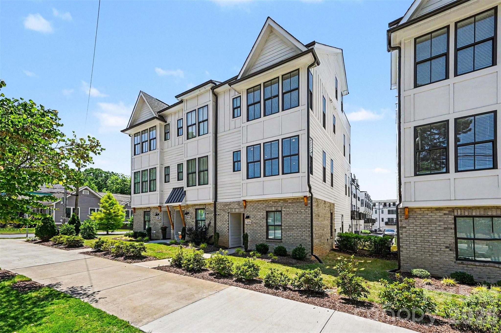 Move in ready, END-UNIT townhome with private ROOFTOP TERRACE and versatile bonus room/bedroom in the heart of West End near Savona Mill! Enjoy modern urban living with craftsman-style architecture, upscale finishes, and an open-concept layout designed for both entertaining and everyday comfort. The main living level features a spacious great room, dining area, and beautifully appointed kitchen with light gray cabinetry, quartz countertops, beveled subway tile backsplash, stainless steel appliances, and designer touches throughout. Premium features include 6” hardwood floors, oak tread staircases, stylish lighting, and abundant natural light. Retreat to your oversized private rooftop terrace — the perfect space for entertaining guests, relaxing outdoors, or creating your ideal work-from-home escape. Additional highlights include a 2-car attached garage with garage door opener and electric vehicle outlet. Located close to restaurants, breweries, shopping, greenways, and all that West End living has to offer. No rental restrictions make this an excellent opportunity for both homeowners and investors alike. Come make this house your home right in time for Summertime in Charlotte!