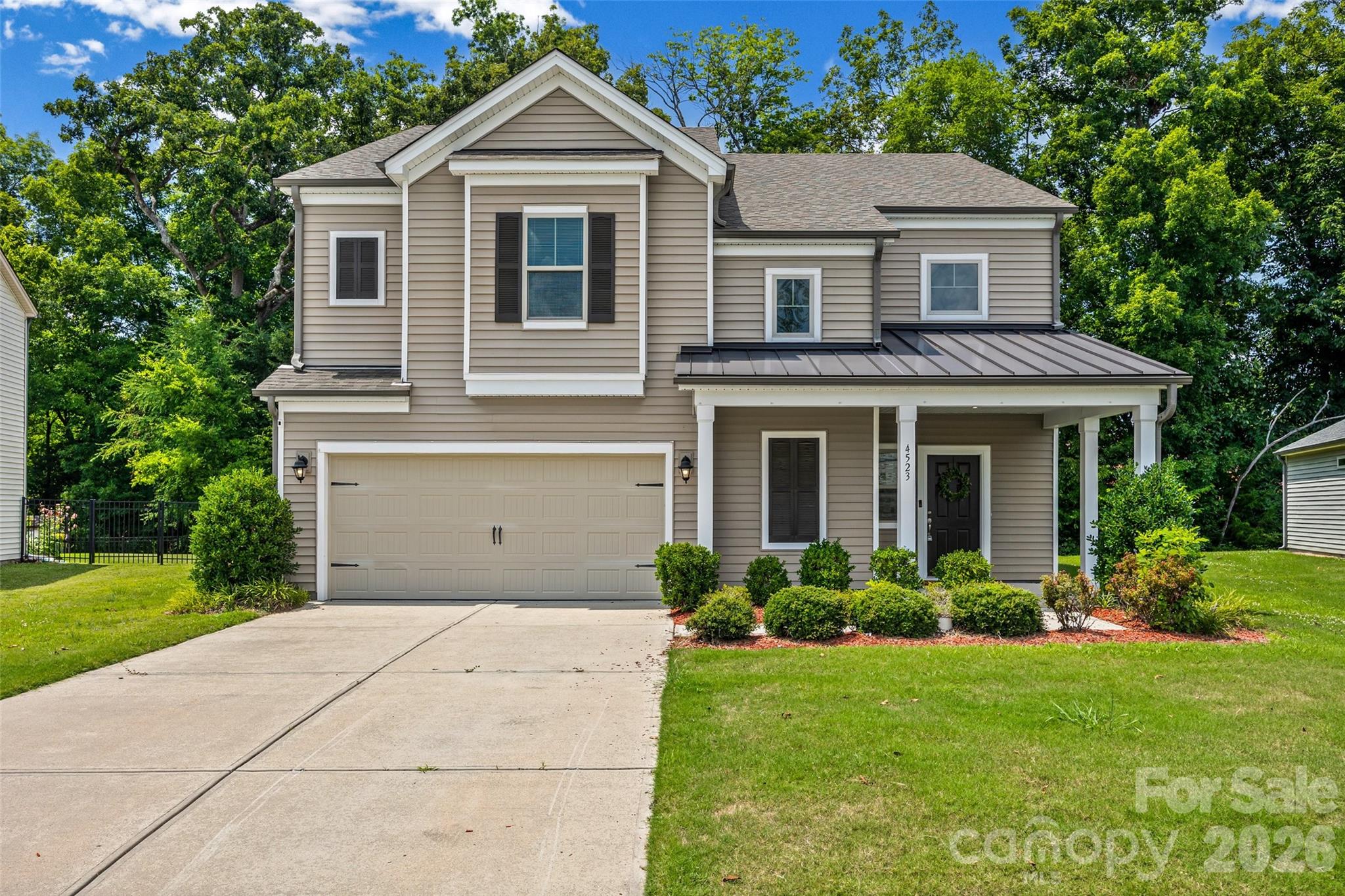 Welcome home to Haywyck Meadows, where space, style, and everyday comfort come together in this beautifully maintained 5-bedroom, 4-bath home offering 3,328 square feet of thoughtfully designed living space.

From the moment you step inside, you'll appreciate the bright, open floor plan that's perfect for both entertaining and everyday living. The main level features a private guest bedroom and full bath, providing an ideal space for overnight guests, multi-generational living, or a home office.

At the heart of the home, the gourmet kitchen is designed to impress with granite countertops, stainless steel appliances, a gas range, an oversized center island, abundant cabinetry, a walk-in pantry, and a convenient butler's pantry—all opening seamlessly to the spacious living and dining areas, making gatherings effortless.

Upstairs, escape to the expansive primary retreat featuring an elegant tray ceiling, spa-inspired ensuite bath, and an oversized walk-in closet. A generous loft offers endless possibilities as a media room, playroom, fitness area, or second living space. One secondary bedroom enjoys the privacy of its own ensuite bath, while two additional bedrooms share a well-appointed full bath.

Fresh interior paint, energy-efficient construction, a tankless water heater, and a fully finished sheetrock garage add exceptional value and move-in-ready appeal.

Step outside to discover one of this home's most desirable features—a .42-acre homesite that extends into a peaceful wooded backdrop, creating privacy and a tranquil setting rarely found in newer neighborhoods. Whether you're enjoying morning coffee on the patio or entertaining friends and family, you'll love the outdoor space.

Residents of Haywyck Meadows enjoy outstanding community amenities including a pool, playground, sidewalks, and clubhouse. Conveniently located just minutes from Charlotte Premium Outlets, Rivergate Shopping Center, Town of Ayrsley, Lake Wylie, I-485, Charlotte Douglas International Airport, Uptown Charlotte, shopping, dining, and entertainment.
 This exceptional home is move-in ready and available for a quick closing. Schedule your private showing today and discover why 4523 Collingham Drive is the perfect place to call home.