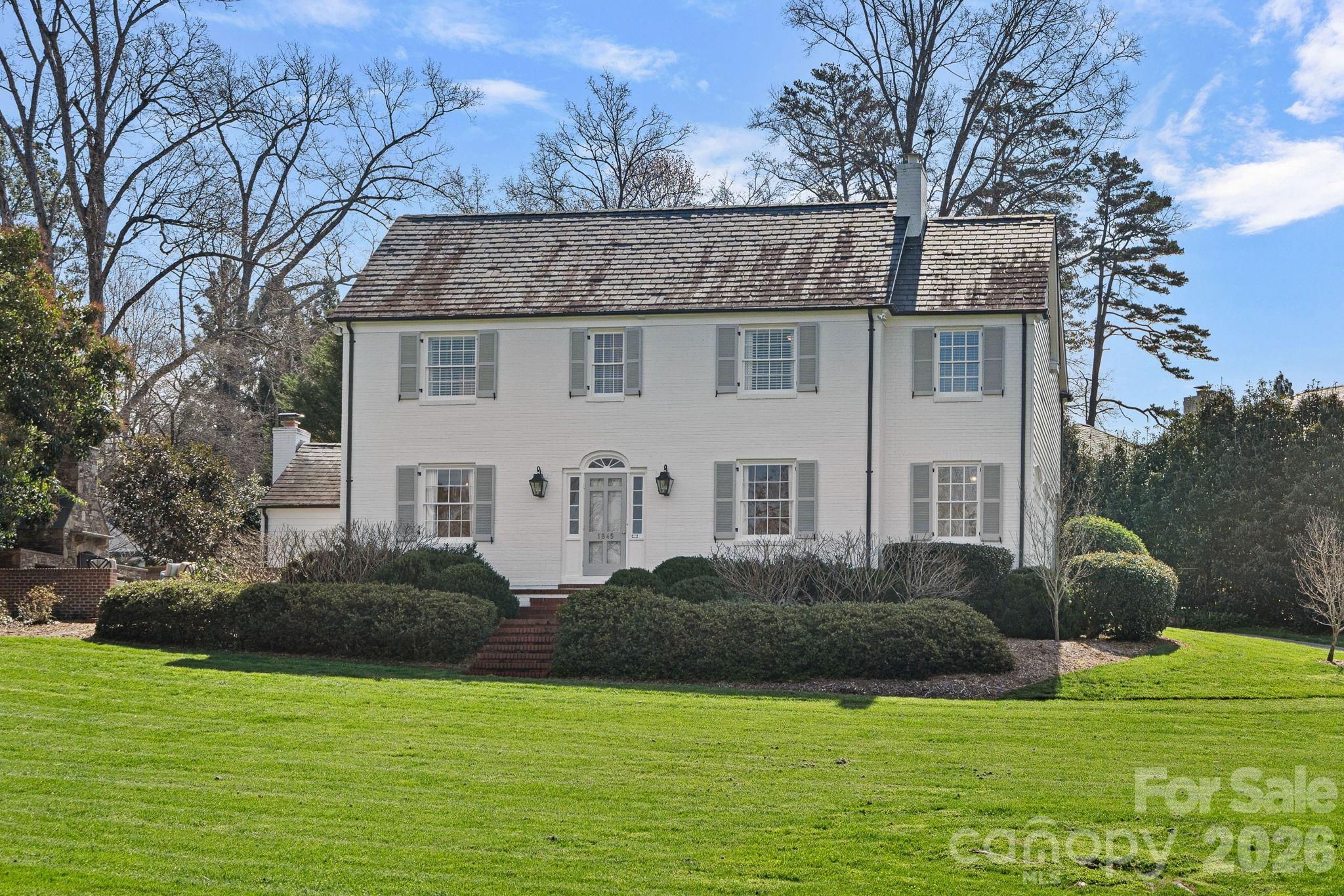 Nestled on a picturesque corner lot in the Mayfair neighborhood (commonly referred to as Myers Park), this classic 1940 home offers timeless architecture, gracious living spaces, and wonderful indoor-outdoor flow. The welcoming foyer opens to elegant formal and informal rooms highlighted by beautiful moldings and arched entryways. The kitchen features marble countertops and backsplash, under cabinet lighting, a Wolf 5-burner cooktop and Dacor double ovens and warming drawer. The inviting family room just off the kitchen opens to the backyard and the stunning stone patio. A charming den provides a quiet retreat, while the sunlit enclosed side porch with wet bar offers a wonderful place for relaxing or entertaining. The upper level features a spacious primary suite with two large walk-in closets and a generous bath, offering excellent potential for future customization. The secondary bedrooms are well-sized. The rec room provides excellent versatile space, ideal for a playroom or gym. The storage room, located in the basement, provides additional flexible space and could be used for wine storage, wrapping room or general storage space. Enjoy outdoor living and entertaining on the beautiful stone patio with fireplace equipped with a gas line starter. This special home offers classic character and charm in a most beloved neighborhood.