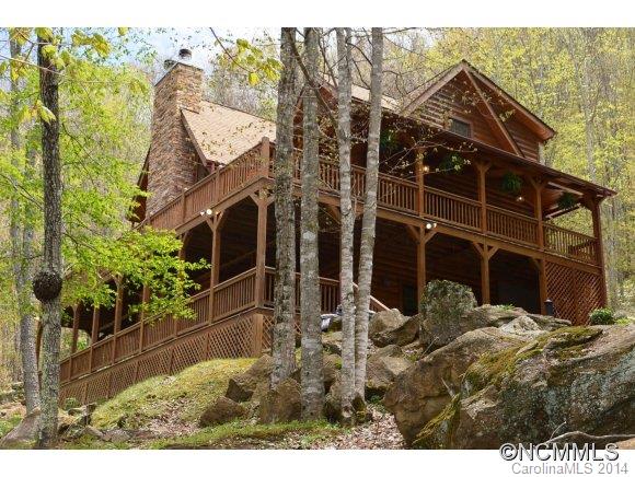 Private setting offers long distance mountain views.. overlook the cascading waterfalls & Fire pit.. Quality log home with main level living for all essentials - 1 step up from garage. Granite in wonderful Kitchen.. wood floors and beamed ceilings.. Comfortable den & game room below.. spacious guest areas.. many details.. wrap around porches on two levels w/ Trek Decking. . Floor plan accommodates the VIEWS.. 4 bedrooms with only 3 bedrm septic