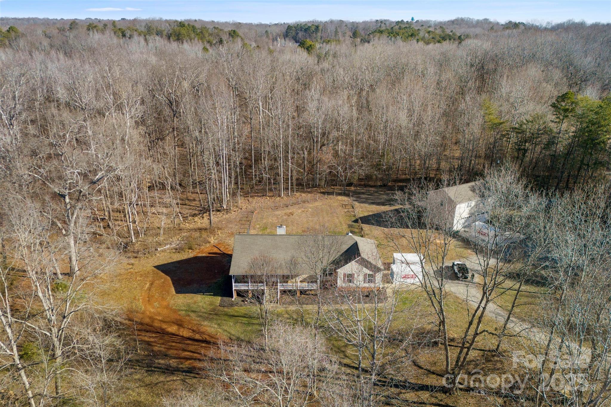 12.74 Acres in Clover – Move-In Ready for Your Hobby Farm or Dream Homestead! This 3-bedroom, 2-bath ranch offers the perfect blend of comfort and function on versatile land in a peaceful setting. Inside features hardwood floors, a cozy fireplace, and spacious rooms with fresh, neutral paint. Outside, the land is ready for livestock—chickens, goats, sheep, pigs, etc. A creek runs along the back of the property, adding natural charm. Bonus: a detached garage with a separate 2-bedroom, 1-bath living space with its own kitchen and laundry—ideal for guests, rental income, or multigenerational living. Minutes from downtown Clover’s shopping, dining, parks & rec, and zoned for top-rated Clover schools! Schedule your private tour today!