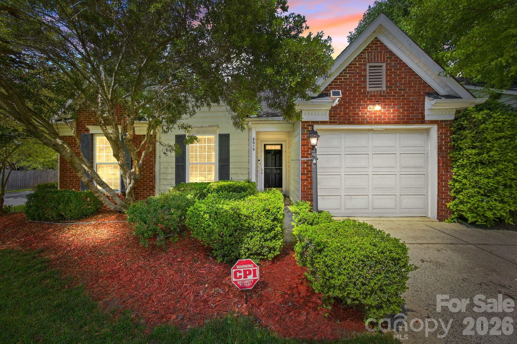 Welcome home to this charming brick and vinyl ranch perfectly situated on a desirable corner lot. This meticulously maintained one-story floor plan features an expansive great room with a soaring vaulted ceiling, a ceiling fan, and a cozy fireplace, creating an inviting atmosphere for relaxation or entertaining. The spacious kitchen offers an abundance of cabinet and countertop space and comes fully equipped with a suite of appliances including a gas range, dishwasher, and refrigerator— approximately two years  and microwave. The washer and dryer are included. Adjacent to the kitchen is a large, bright dining area ideal for family meals. The primary suite serves as a true retreat, boasting a vaulted ceiling, a large walk-in closet with custom built-in, and a spa-like ensuite bath featuring a garden tub, a separate shower, and two separate sink areas. Two additional generously sized guest bedrooms and a full bath, providing excellent privacy through the split-bedroom layout. Outside, you will find a single-car attached garage featuring a brand-new garage door opener and a private backyard oasis complete with a patio area, a dedicated garden space, and a mature shade tree in the front yard. This brick and vinyl home also includes full gutters for easy maintenance. Conveniently located with easy access to I-485, I-77, and I-85, you are just minutes away from premium shopping, dining, and healthcare facilities.