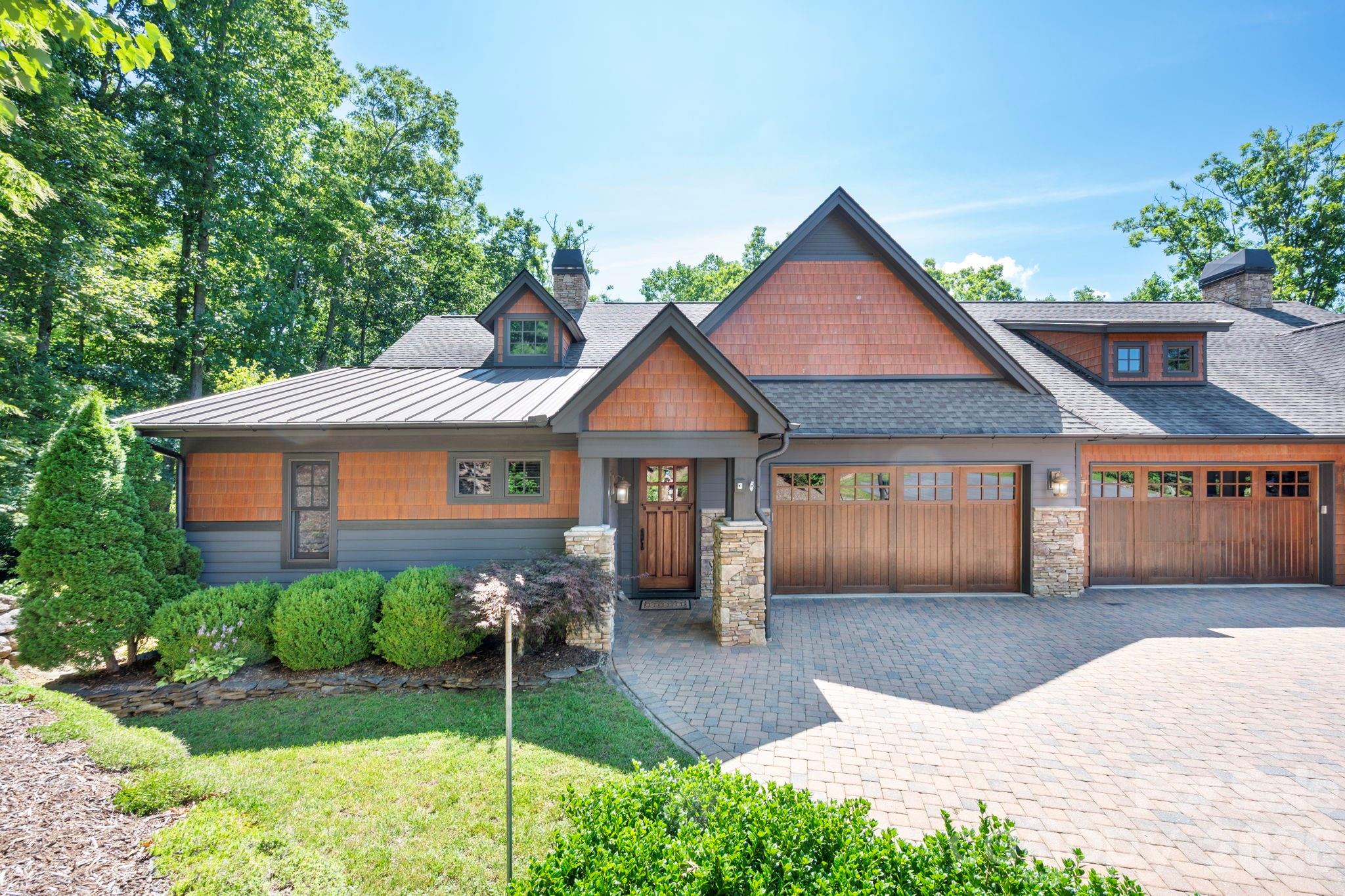 Tucked into a private wooded setting on a quiet cul-de-sac, this Craftsman townhome is a rare Southcliff find, set on a generous .25-acre lot with beautiful mountain views. Morning coffee on the deck, evenings under the trees, and direct access to the Southcliff trail system create a lifestyle that feels both peaceful and active.

The main level is designed for easy living with a primary suite, laundry, and bright living spaces filled with natural light. Vaulted ceilings and expansive windows bring the outdoors in, while the kitchen features granite countertops, newer appliances, and thoughtful storage solutions. An easy flow between the kitchen, living areas, and outdoor spaces makes entertaining a natural part of everyday life.

The lower level offers exceptional flexibility with an additional bedroom and ensuite bath, family room, and large bonus room ideal for a home office, fitness studio, creative space, or media room. Abundant storage and workshop space add even more functionality.

Two levels of decks extend the living space outdoors, surrounded by the peaceful forest setting. Built-in speakers make these inviting spaces ideal for dining, relaxing, or gathering with friends and family.

Southcliff offers 175 acres of natural green space and more than six miles of walking and hiking trails connecting five private parks, a family campground, playground, covered pavilion with outdoor fireplace, fire pits, and grilling areas. With direct trail access from the property, enjoying it all is right outside your door.

Additional highlights include an encapsulated crawl space with dehumidifiers, whole-house central vacuum, custom closet shelving, and generous storage. More than a townhome, this is a private mountain retreat with the ease of community living and nature at your doorstep.
