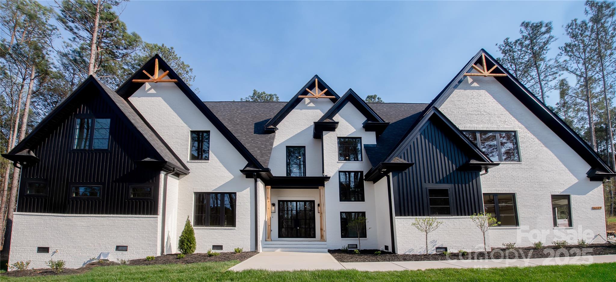 Experience true elegance in this exquisite newly built home offering over 4,000 square feet of luxury living. This 4-bedroom, 3.5-bath masterpiece is designed with impeccable attention to detail and the finest high-end finishes throughout. From 26’ ceilings and expansive windows to wide-plank hardwood floors and custom millwork, every inch speaks sophistication. The gourmet chef’s kitchen features Thermador appliances, quartzite countertops, and 2 oversized islands, perfect for entertaining. Retreat to the lavish primary suite with spa-inspired bath and generous walk-in closets. Additional highlights include a formal dining area, wine room, and a spacious great room with a statement fireplace. Step outside to a covered patio and sprawling Trex deck ideal for year-round enjoyment. This hand drawn home is built to impress and crafted for comfort, delivering an elevated lifestyle in every way. Schedule your private tour today and experience the height of luxury living.
