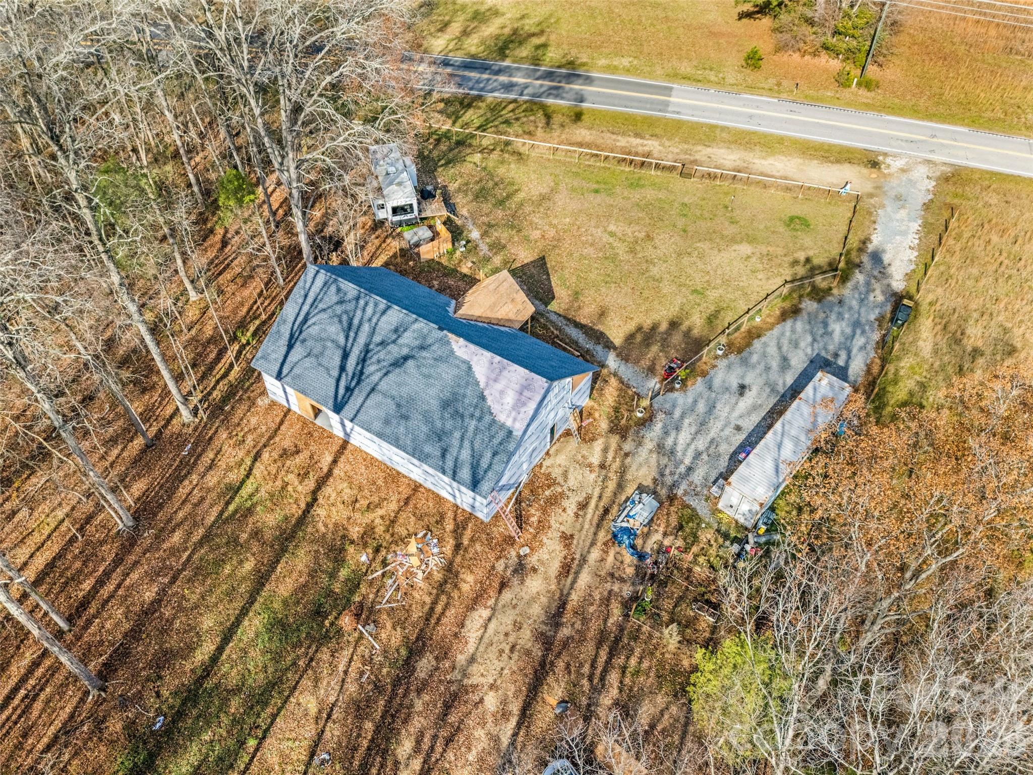 Check out this unique opportunity on 2.5 acres! This incomplete new construction home is ready for someone else to come in and complete their vision. Finish this one level, 2400 square foot house the way you want it done! The roof trusses are not load bearing, so most of the interior walls can be relocated to fit your needs. The well has already been installed and the land has already been perc'd for a 2 bedroom septic system. Convenient to downtown York, Clover, Lake Wylie, and Rock Hill in a country setting.