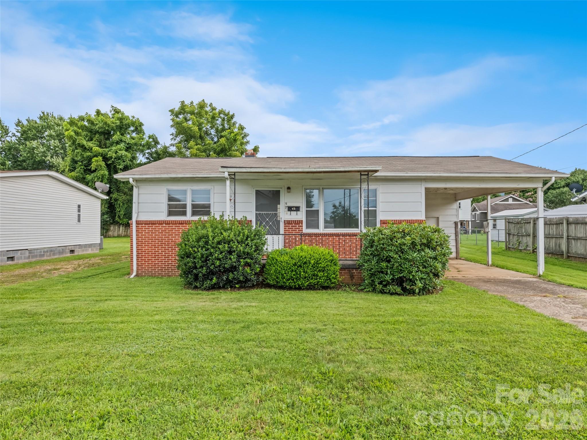 Brimming with potential, this classic 1963 ranch home offers an incredible opportunity for investors, flippers, or savvy buyers ready to build instant equity. Featuring 2 bedrooms, 1 bathroom, and a classic eat-in kitchen awaiting your modern touch, the foundation is set for transformation. Original hardwood floors run through the living room and bedrooms, just waiting to be refinished to their full glory. Situated on a level lot with city amenities in the Town of Waynesville, this property combines prime location with low-maintenance appeal. Practical additions include a single carport with a dedicated storage room for tools and equipment. Bring your vision, tools, and contractor—homes with this much upside and city convenience don't stay on the market long! Selling as-is.
