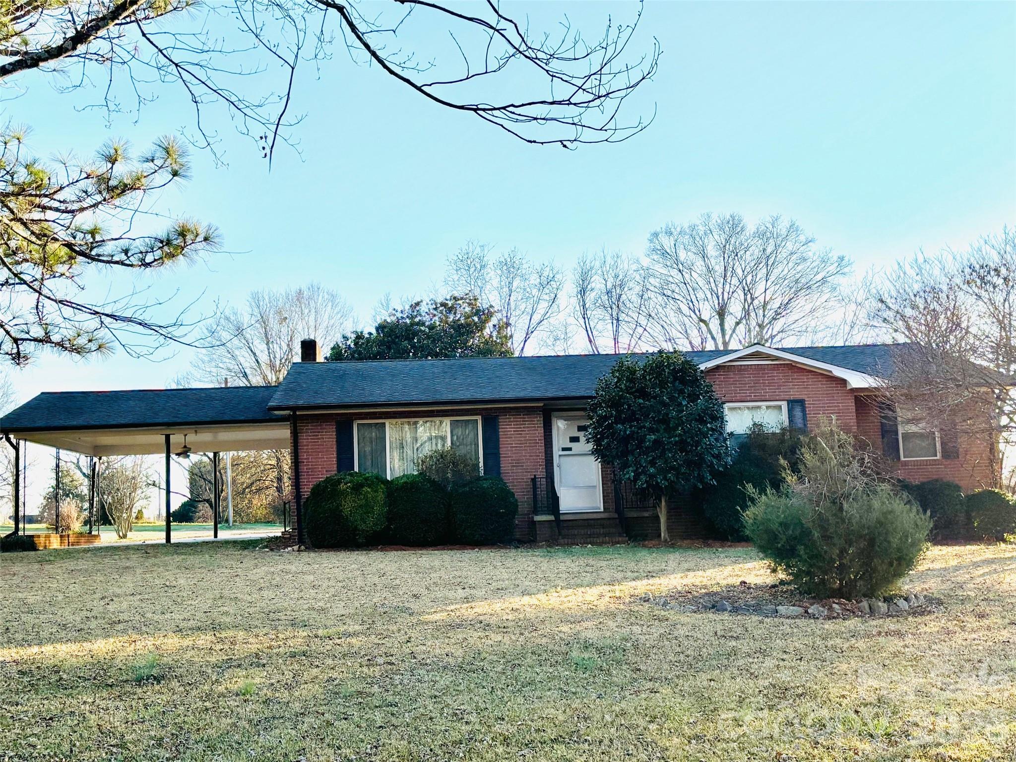 PRIVACY AT ITS BEST! Welcome to this 3 bedroom, 2 bath brick home nestled on 2 acres.  This is a one of a kind property! If you are looking for a home with LAND conveniently located to a grocery store, restaurant and more this is it! The  large den has beautiful wood walls and a  fireplace. There is a spacious living room which could also be used for the dining room.The kitchen has white wood cabinets with linoleum floors. Beautiful open yard with a few pines. There is also a large tractor/shed with a lean-to and another smaller shed on the property. Enjoy gardening, entertaining, and gorgeous sunsets. Additional parcels available for purchase. Call for info!