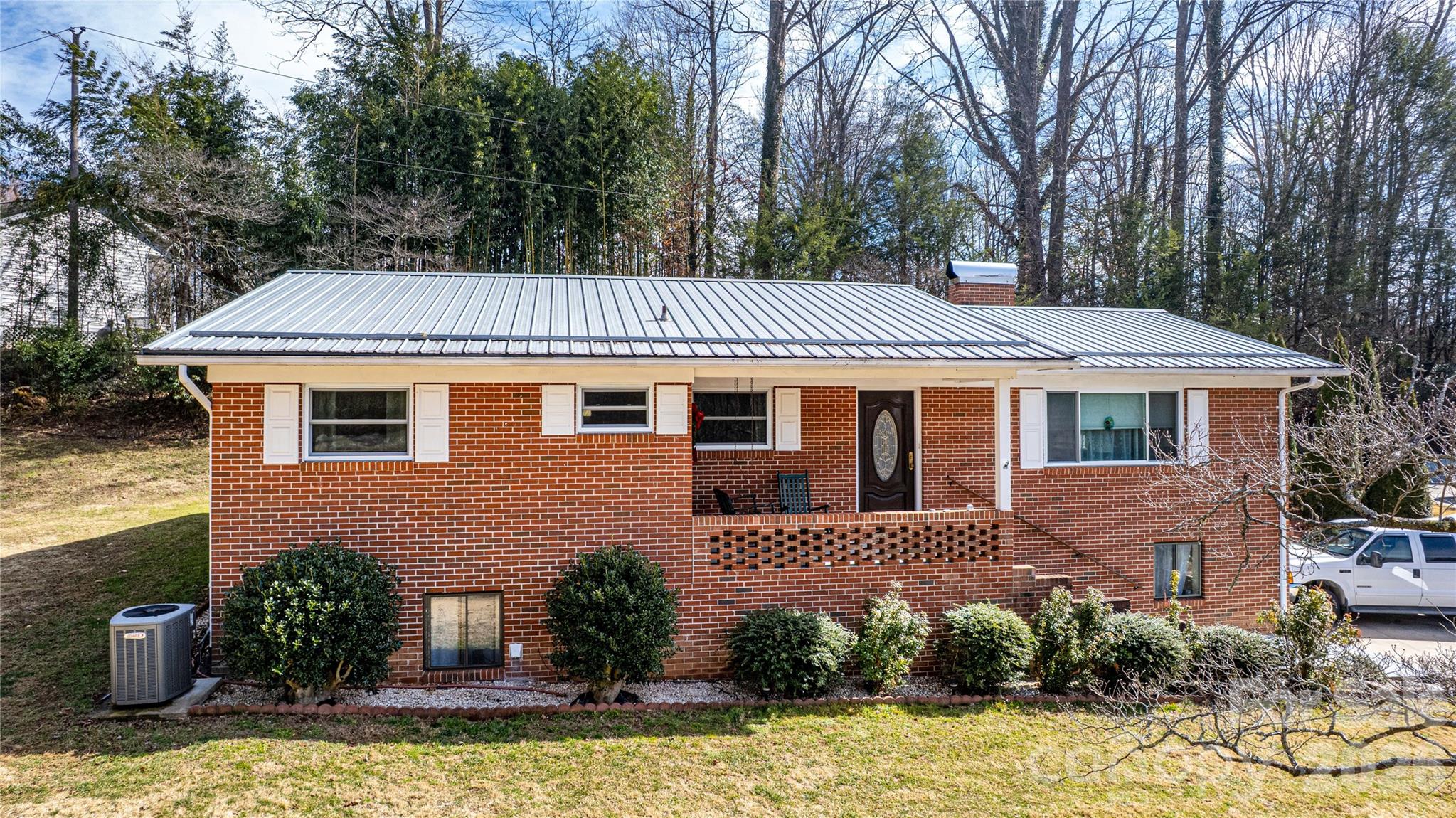 Welcome to 356 Pleasant Hill Drive. This well-maintained brick home nestled on a private lot less than five miles from downtown Brevard. This inviting property offers the perfect blend of privacy and convenience. Located with easy access to local shops, dining, and outdoor recreation. Inside, you’ll find beautiful hardwood floors and a comfortable layout designed for everyday living. The heated and cooled sunroom provides a bright, relaxing space to enjoy year-round, while the conditioned bonus room offers flexibility for a home office, gym, or additional living space. Outside, the property features beautiful landscaping, generous yard space, and plenty of parking—ideal for guests, multiple vehicles, or RV/Camper. An entry garage door into the basement adds convenience and additional functionality. Whether you're looking for a peaceful retreat close to town or a home with versatile space and great outdoor surroundings, this property offers a wonderful opportunity to enjoy the best of Mountain living.