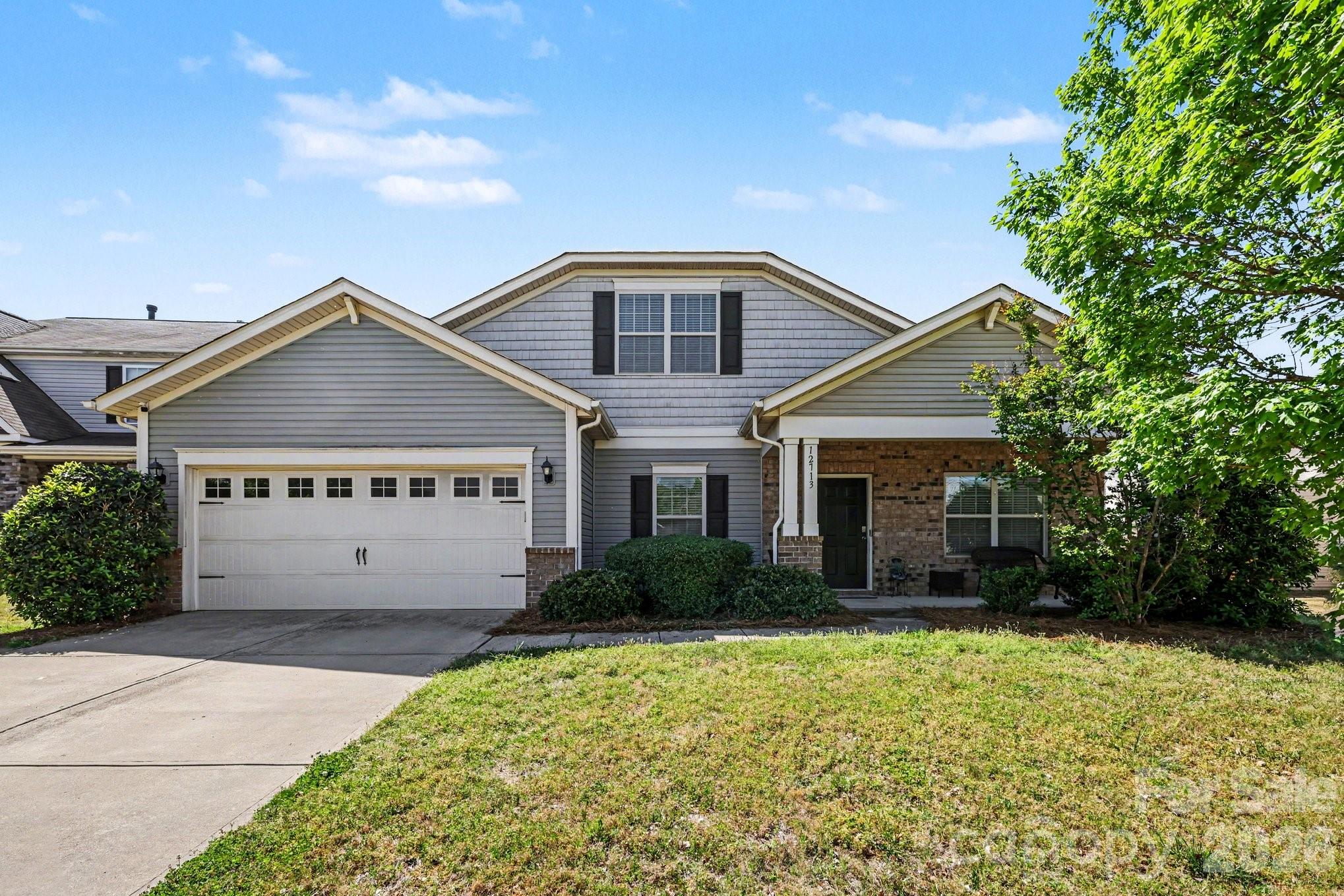 Beautiful five-bedroom home in Steele Creek, built in 2014, offering spacious and versatile living with over 2,000 square feet on the main level. This well-designed home features a two-car garage, a main-level primary suite with private bath, plus two additional guest bedrooms and a full hallway bath on the main floor. The upper level includes two additional bedrooms and another full bath, providing ideal flexibility for guests, office space, or multi-generational living. The kitchen is equipped with stainless steel appliances, completing this attractive and functional home.