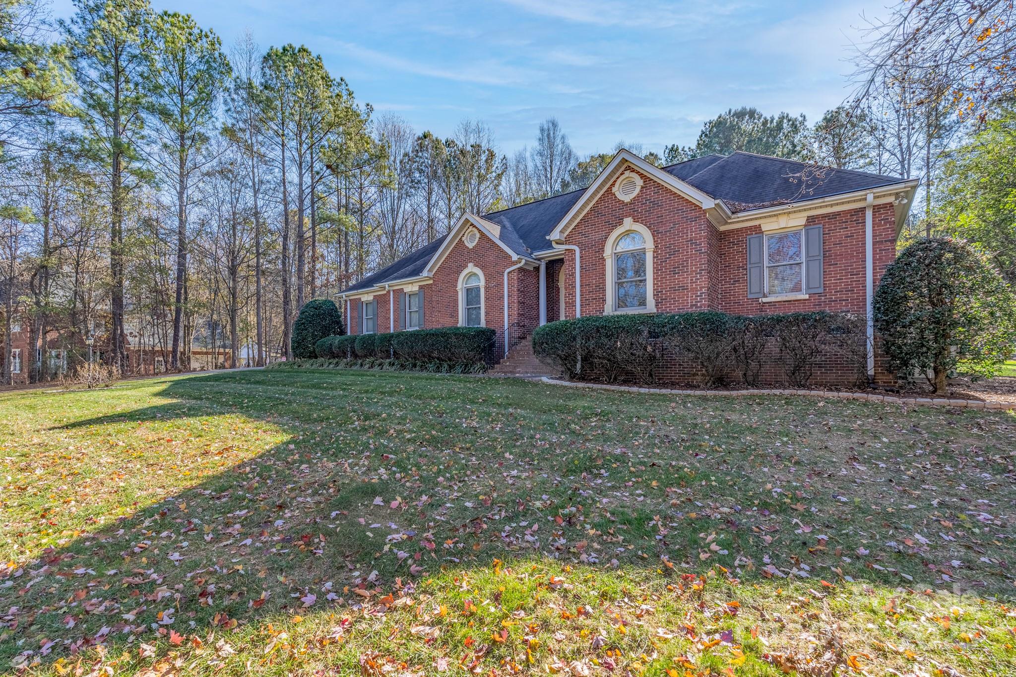 Welcome to this spacious, custom all-brick ranch home in prestigious Vander Lakes, set on a 1.021  acre lot.  This home combines classic finishes, functional spaces, community appeal and room to grow.  Vander Lakes is an established neighborhood known for large wooded lots, quality-built brick homes, and proximity to shopping and major routes. Upon entering this beautiful home you will notice the soaring vaulted ceilings in the great room which adds volume and a dramatic open feel. You’ll love your kitchen with new granite countertops, tiled backsplash and a raised breakfast bar. The formal dining room showcases a deep tray ceiling, wainscoating and elegant detail that enhances the space. This five bedroom, 3.5 bath home has the best of both worlds.  The primary ensuite is located on the left side of the home offering exclusive privacy for the homeowners with double french doors to the outside, while the primary bathroom has double vanities, a jetted tub, separate shower and a spacious walk-in closet. The additional three bedrooms on the right side of the home includes a newly remodeled bathroom with a handicap accessible shower and grab bars.  The 5th bedroom/bonus upstairs is ideal for an office, media room, playroom, or guest suite. This traditional layout combines formal and casual living areas that flows well for everyday life and entertaining.  Hardwood flooring is found throughout the main living areas – durable and stylish, with carpet in only one bedroom and the bonus upstairs. Entertain on your large deck overlooking a private backyard – great for grilling, entertaining, or simply unwinding.  An included 12x16 shed is an excellent space for lawn equipment, tools, or hobby gear. With low HOA’s and sought-after Clover Schools this neighborhood has the feel that is perfect for families and commuters alike. You will know you are home!