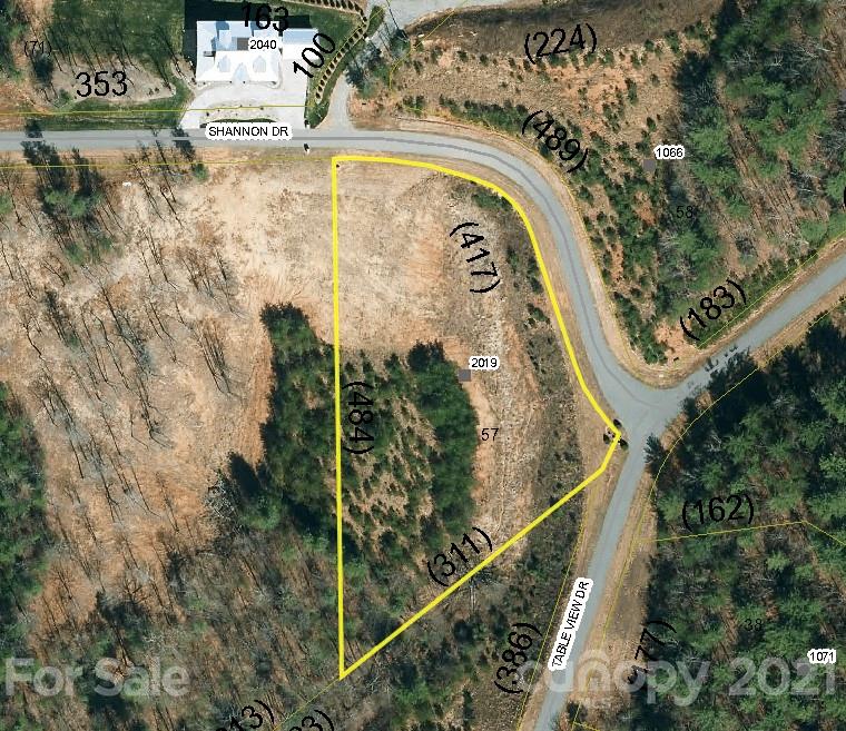 South Mountain views from this lot in desirable Old Oaks Estates. Lot is partially cleared and gently rolls for a perfect walk-out basement plan. Plenty of space on this 1.91 acre corner lot. Old Oaks has high speed fiber internet. Privacy and security in this gated community. Community has amazing view of Table Rock, Hawksbill, South Mountains, and Grandfather Mountain.