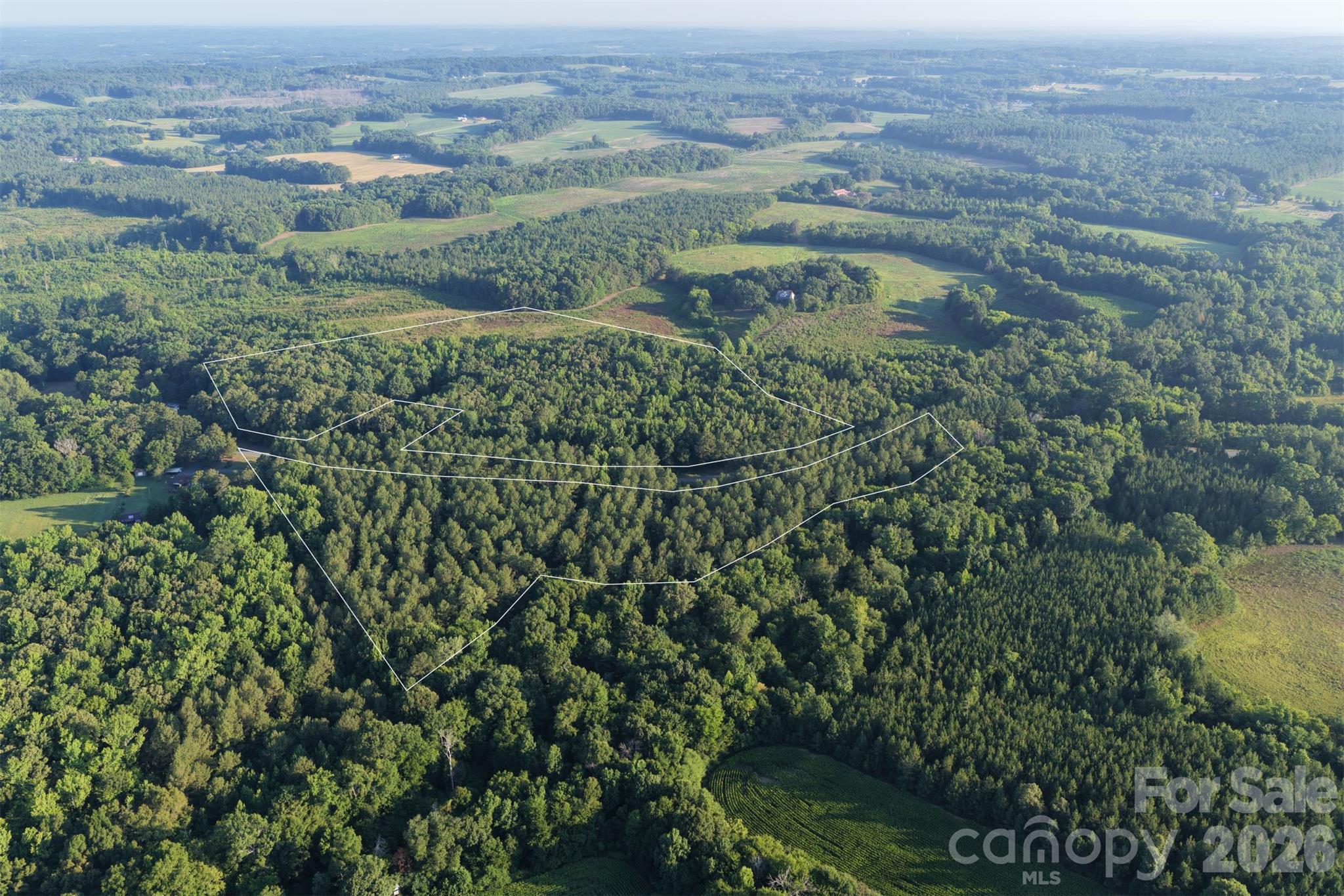 The property consists of two parcels / 6544-04-72-7012 34.73 acres and 6544-04-82-8106 0.22 acres. The tract is divided by S. Stanly School Road with approximately 2300 feet of road frontage. There are 28.95 acres that are wooded with a mix of pine and hardwood and 6 acres are open pasture. The southeast boundary of the property is Hardy Creek. The Town of Norwood has water available at the round about and runs down Cottonville Road. It is approximately 1/2 mile from this property. The property is zoned Residential / Agricultural with stick built, modular and manufactured homes allowed.