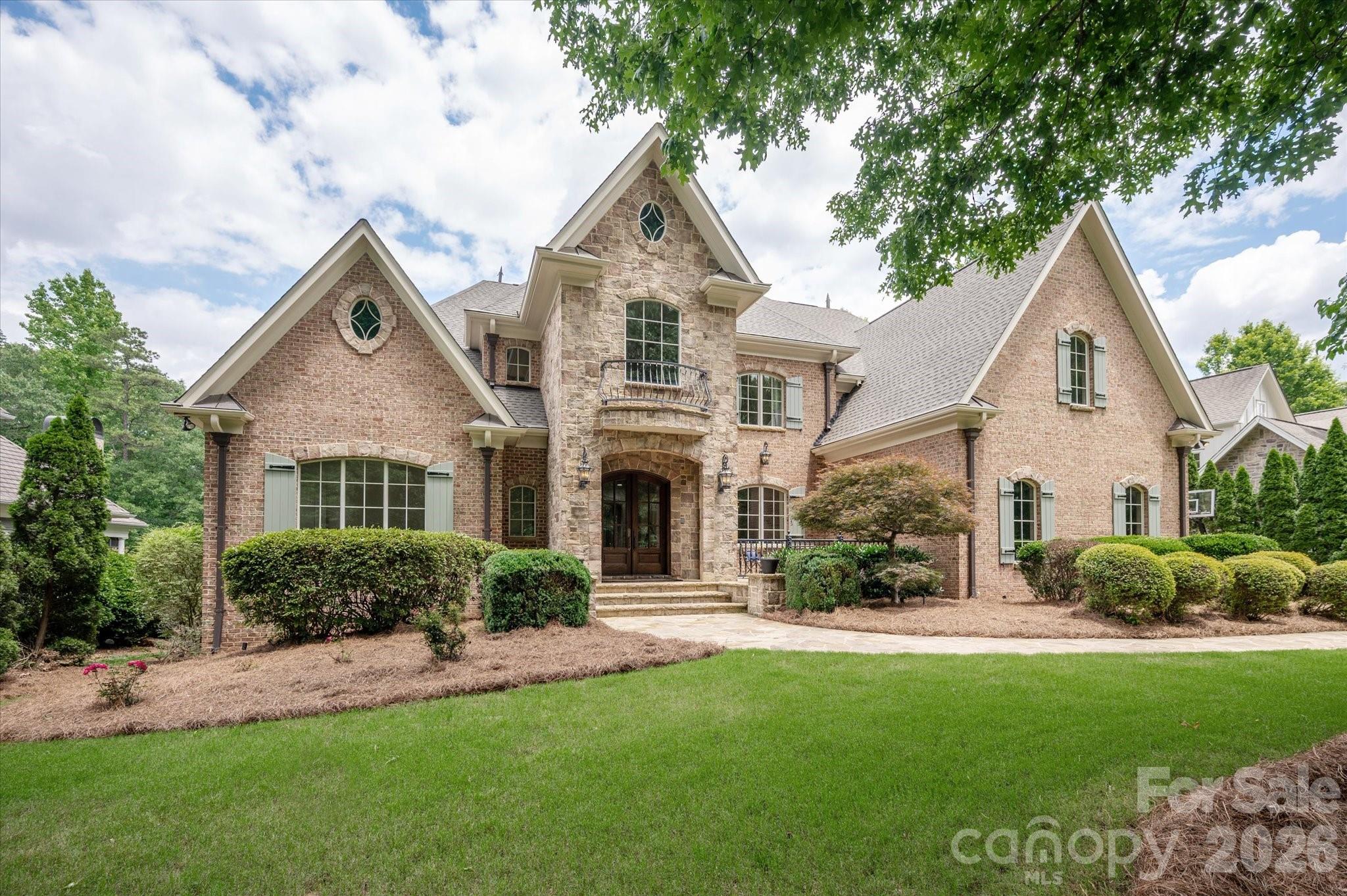 Welcome to one of Springfield's most distinguished golf course estates. A Showcase residence where timeless architecture, exceptional craftsmanship, and modern luxury converge. Perfectly positioned on one of the community's most coveted streets, this extraordinary one of a kind full brick basement home offers an unparalleled lifestyle within Fort Mill's premier golf course community. From the moment you enter, a breathtaking two-story foyer and sweeping curved staircase (acclaimed local artist) create a dramatic first impression, setting the stage for over three levels of impeccably designed living space. Every detail has been thoughtfully curated, from the extensive custom millwork, designer lighting, coffered and vaulted ceilings and other refined architectural elements found throughout.

At the heart of the home, a completely reimagined chef's kitchen showcases luxury appliances, exquisite finishes, and exceptional functionality, seamlessly connecting to both formal and casual living spaces. The main level is anchored by a private owner's retreat and a secondary guest suite/executive office (currently used as a Mahjong room) offering convenience and flexibility for today's lifestyle.

Designed for both grand entertaining and comfortable everyday living, the home features 7 spacious bedrooms, 5 full baths, and 3 half baths. Multiple fireplaces throughout the residence provide warmth and ambiance while enhancing the home's timeless appeal.The walkout daylight basement is a destination unto itself, complete with a private in-law suite and kitchenette, state-of-the-art media room with projector, screen and built in speakers, billiard room (pool table conveys); and expansive recreation spaces.

Outdoor living rivals that of a private resort. Three seperate terraces along the rear of the home overlook the picturesque golf course, the backyard oasis features a sparkling saltwater pool and spa, outdoor fireplace, and multiple areas designed for relaxation and entertaining. 

With a newer roof installed in 2025, a flawlessly executed floor plan, and countless luxury upgrades, this remarkable estate offers a rare opportunity to own one of Springfield's most impressive homes. Elegant yet inviting, grand yet comfortable, this is luxury living without compromise.

Beyond this extraordinary residence awaits the unparalleled Springfield lifestyle—where an 18 hole Public golf course, Included resort-style amenities (Clubhouse; fitness center; 3 pools;Tennis and pickleball courts; playground; pocket parks etc), and access to the Anne Springs Close Greenway create one of the Charlotte region's most coveted living experiences.